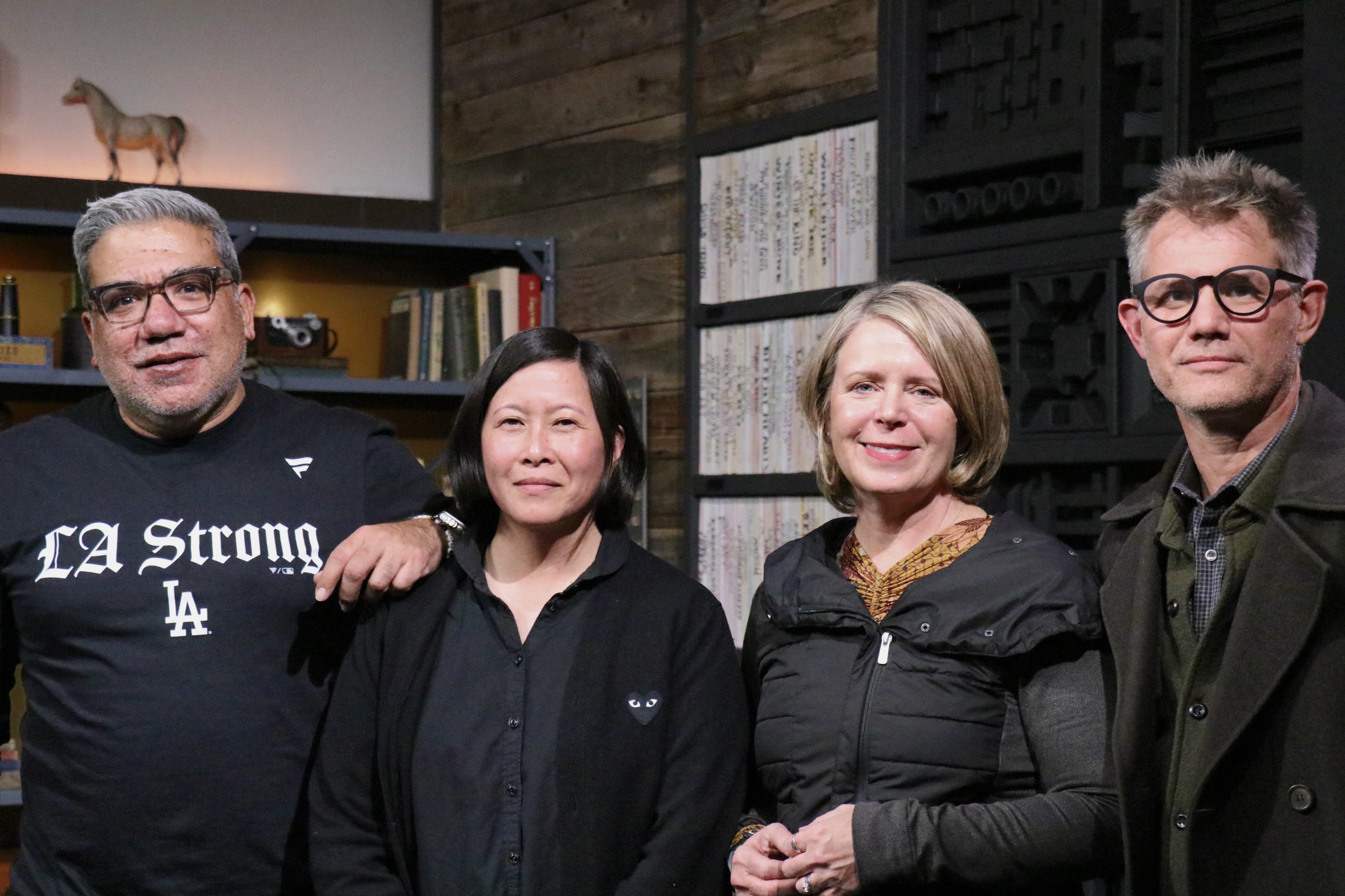 Eugene Hernandez, Kim Yutani, Amanda Kelso, and John Nein pose for photographs after a press reception Wednesday in Park City ahead of the 2025 Sundance Film Festival.