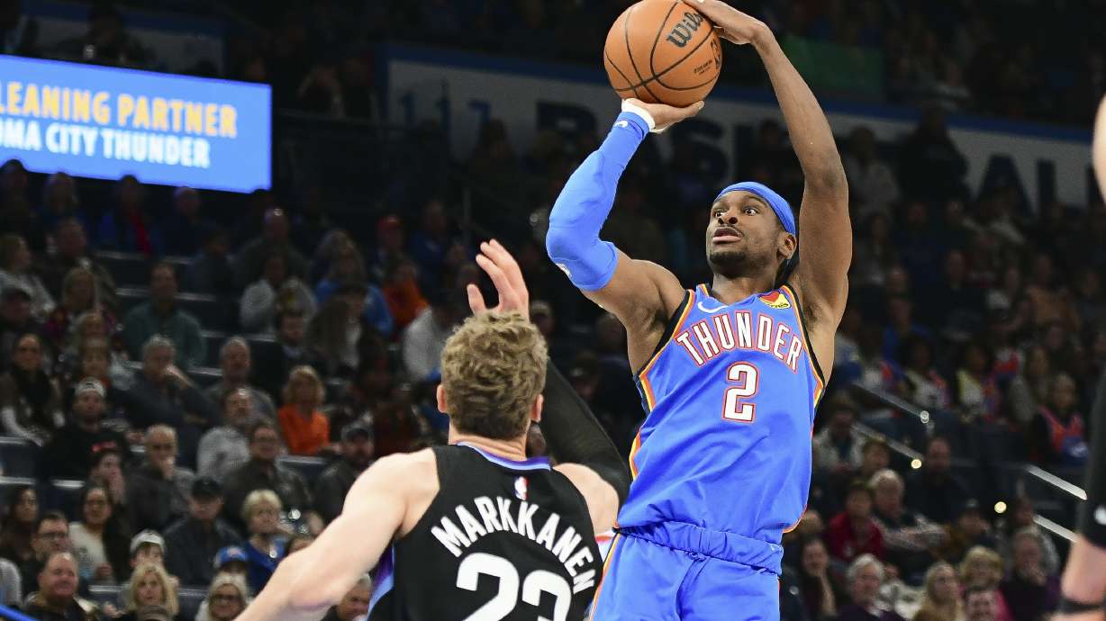 Oklahoma City Thunder guard Shai Gilgeous-Alexander (2) shoots over Utah Jazz forward Lauri Markkanen (23) during the first half of an NBA basketball game, Wednesday, Jan. 22, 2025, in Oklahoma City.