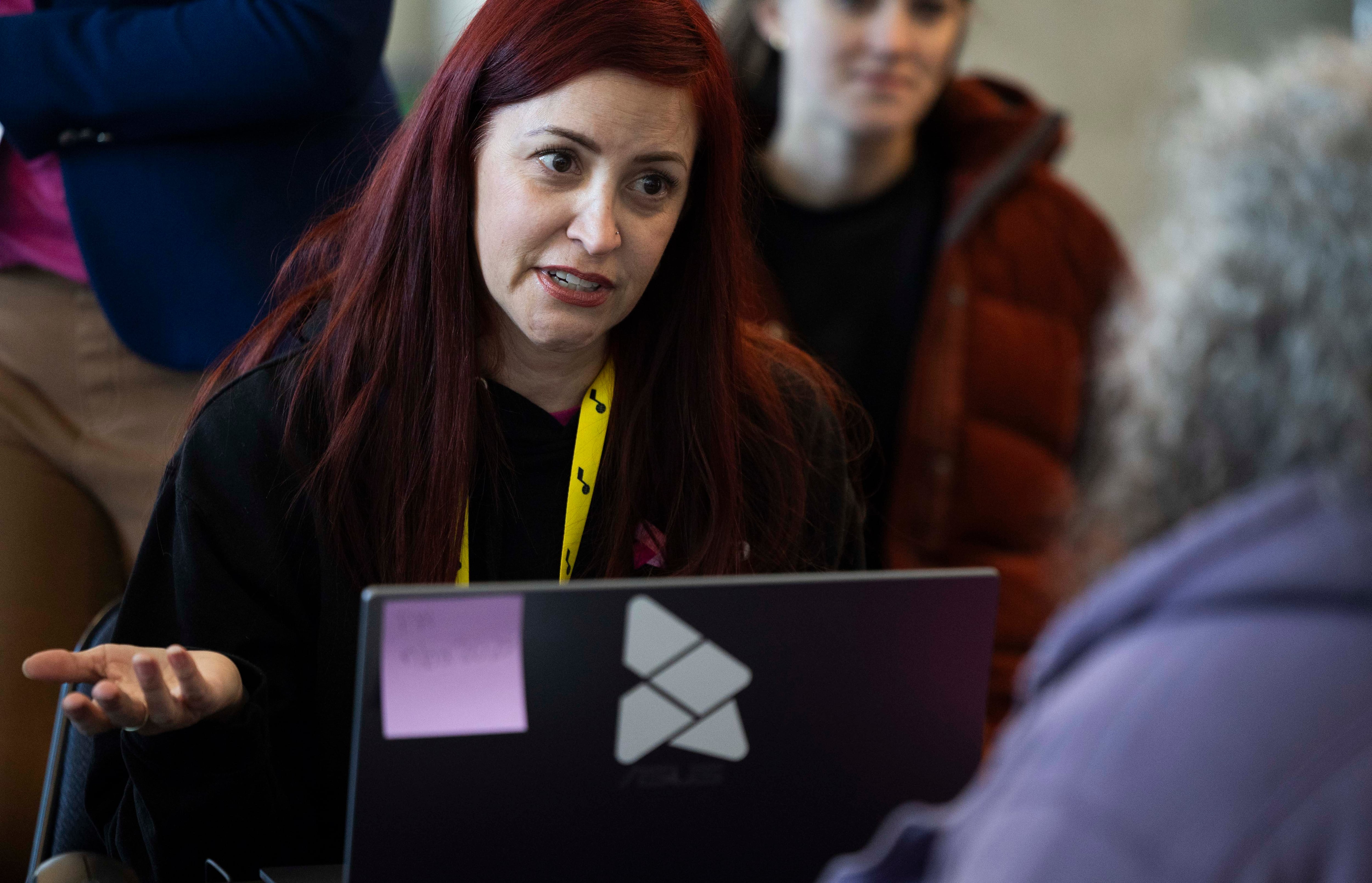 Arianne Fox helps someone with expungement paperwork during the 2025 Utah Expungement Summit at the Delta Center in Salt Lake City on Wednesday.