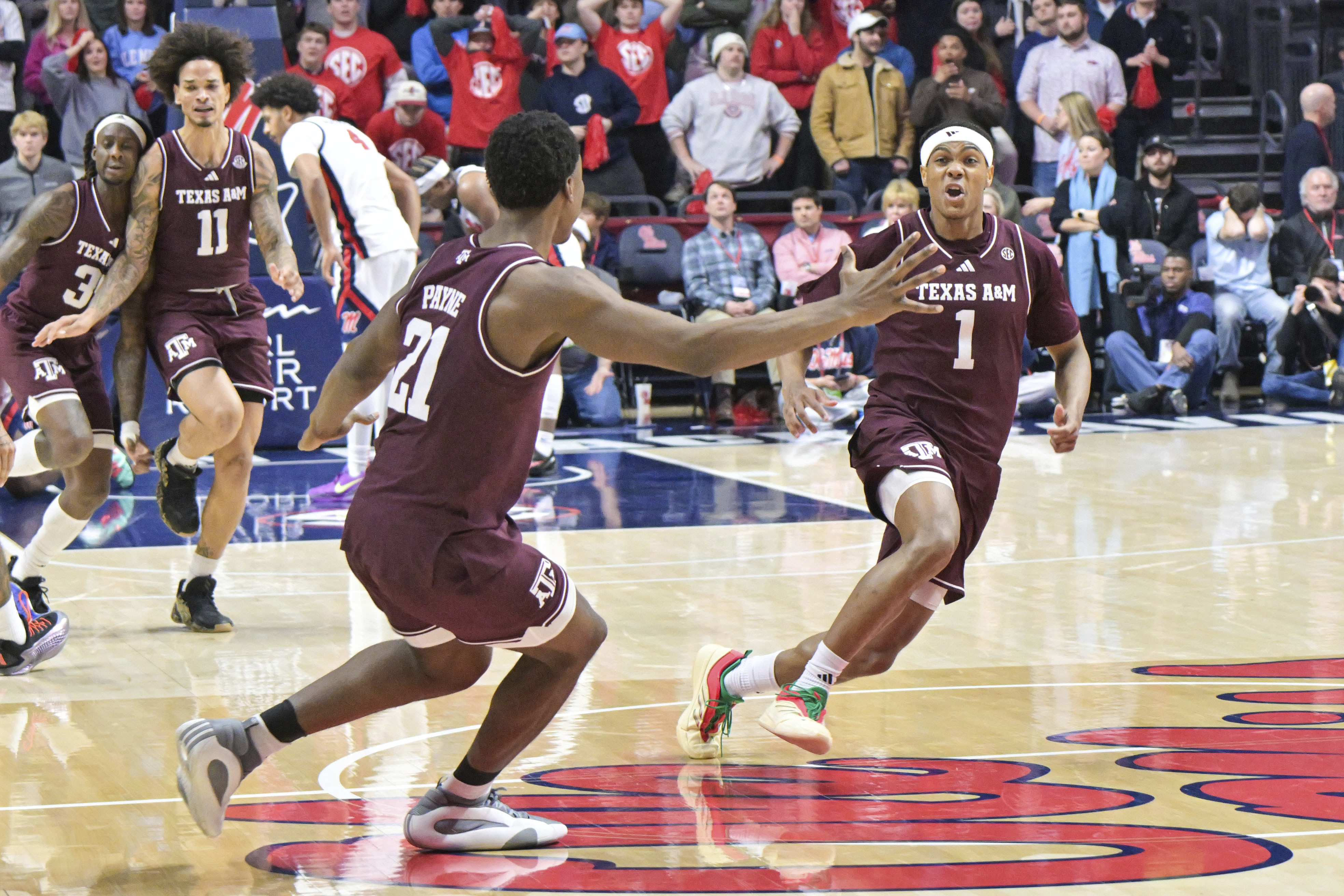 Texas A&M guard Zhuric Phelps (1) and Texas A&M forward Pharrel Payne (21) celebrate the win over Mississippi during the second half of an NCAA college basketball game in Oxford, Miss., Wednesday, Jan. 22, 2025.