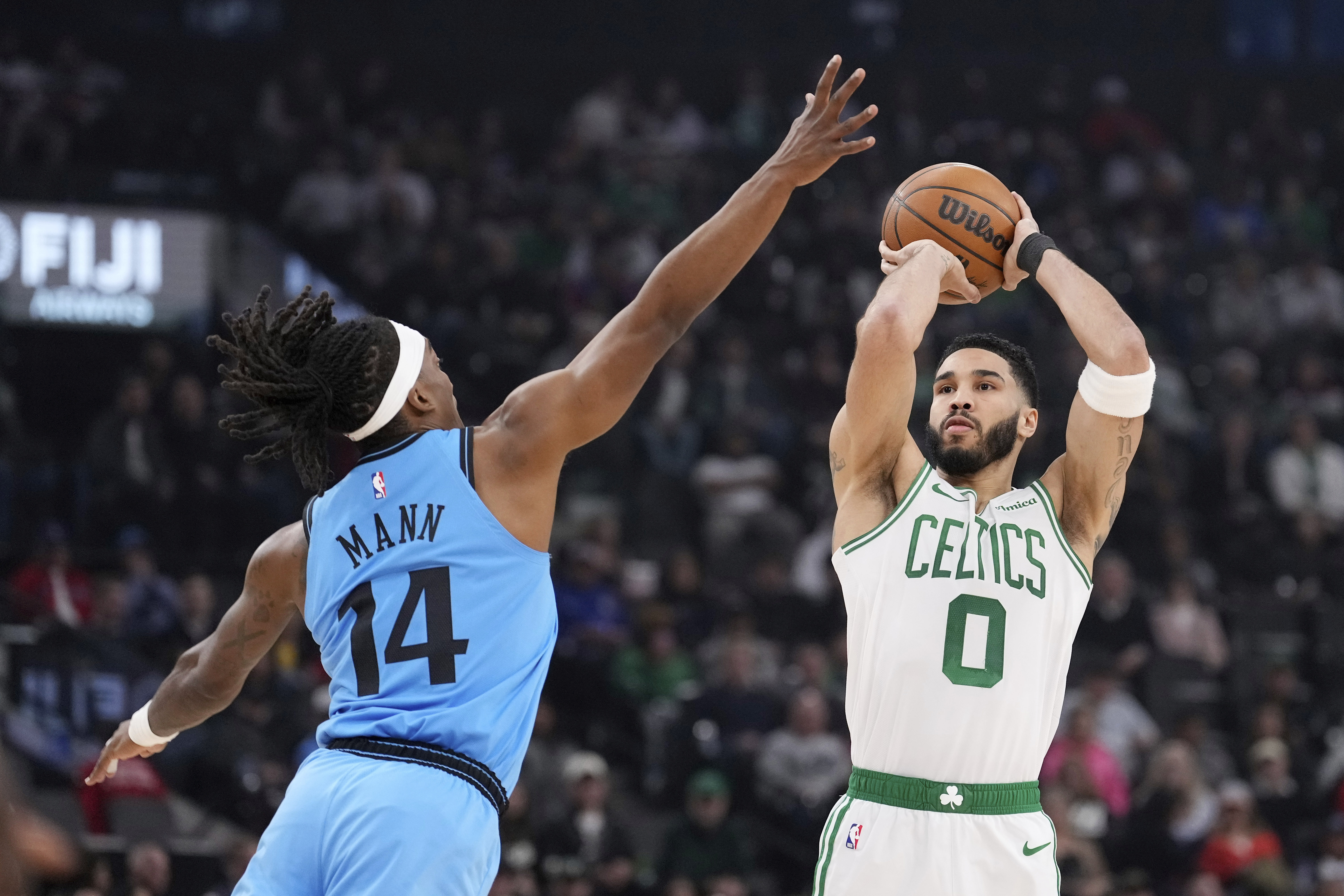 Boston Celtics forward Jayson Tatum, right, shoots as Los Angeles Clippers guard Terance Mann defends during the first half of an NBA basketball game, Wednesday, Jan. 22, 2025, in Inglewood, Calif.