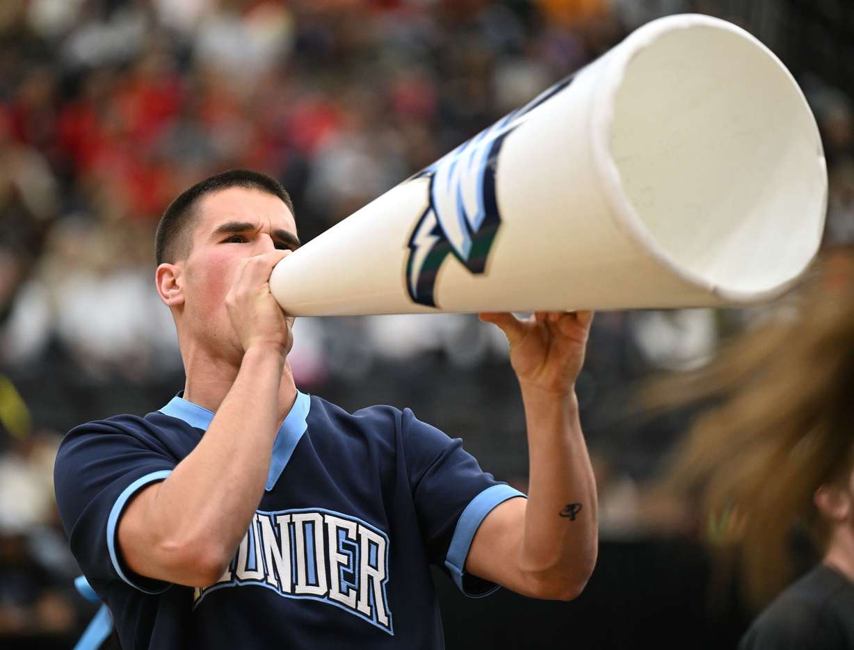 A Westlake cheerleader yells into a megaphone as cheerleading teams from 6A compete at UVU in Orem on Wednesday, January 22, 2025.