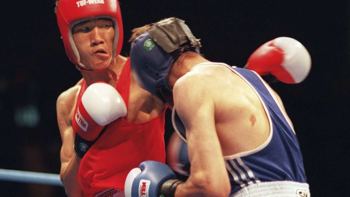 FILE - Thailand's Somluck Kamsing, left, competes against Bulgaria's Serafim Todorov during the gold medal 57kg featherweight boxing match at the Centennial Summer Olympic Games in Atlanta Sunday, Aug. 4, 1996.