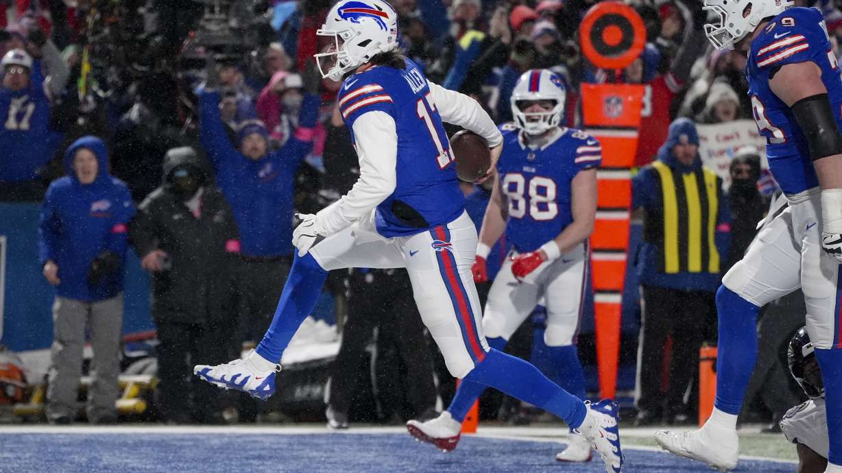 Buffalo Bills quarterback Josh Allen (17) carries the ball into the end zone to score a touchdown against the Baltimore Ravens during the second quarter of an NFL divisional playoff football game, Sunday, Jan. 19, 2025, in Orchard Park, N.Y.