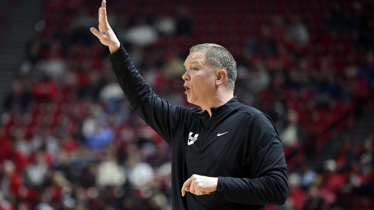 Utah State head coach Jerrod Calhoun calls to his team during the first half of an NCAA college basketball game against UNLV Wednesday, Jan. 15, 2025, in Las Vegas.