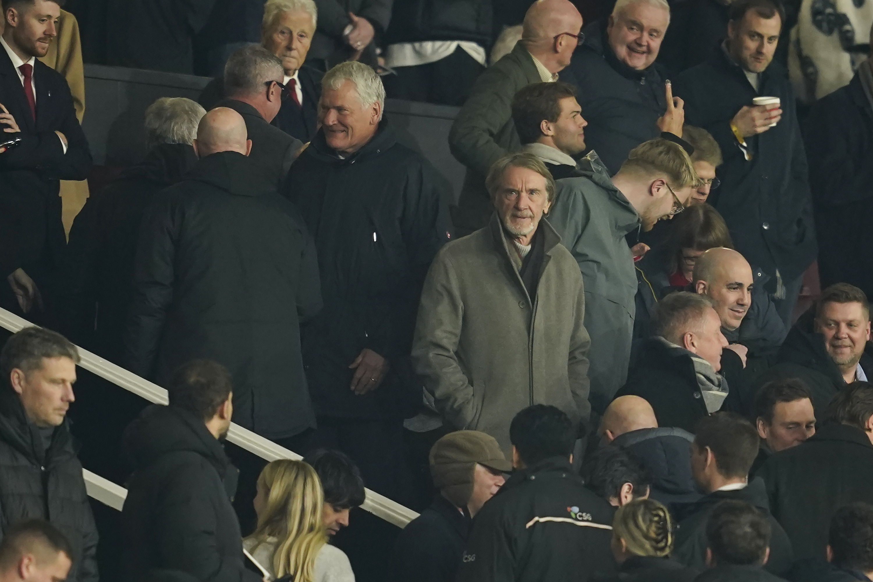 Manchester United owner Sir Jim Ratcliffe, centre right, waits for the start of the English Premier League soccer match between Manchester United and Southampton at the Old Trafford stadium in Manchester, England, Thursday, Jan. 16, 2025.