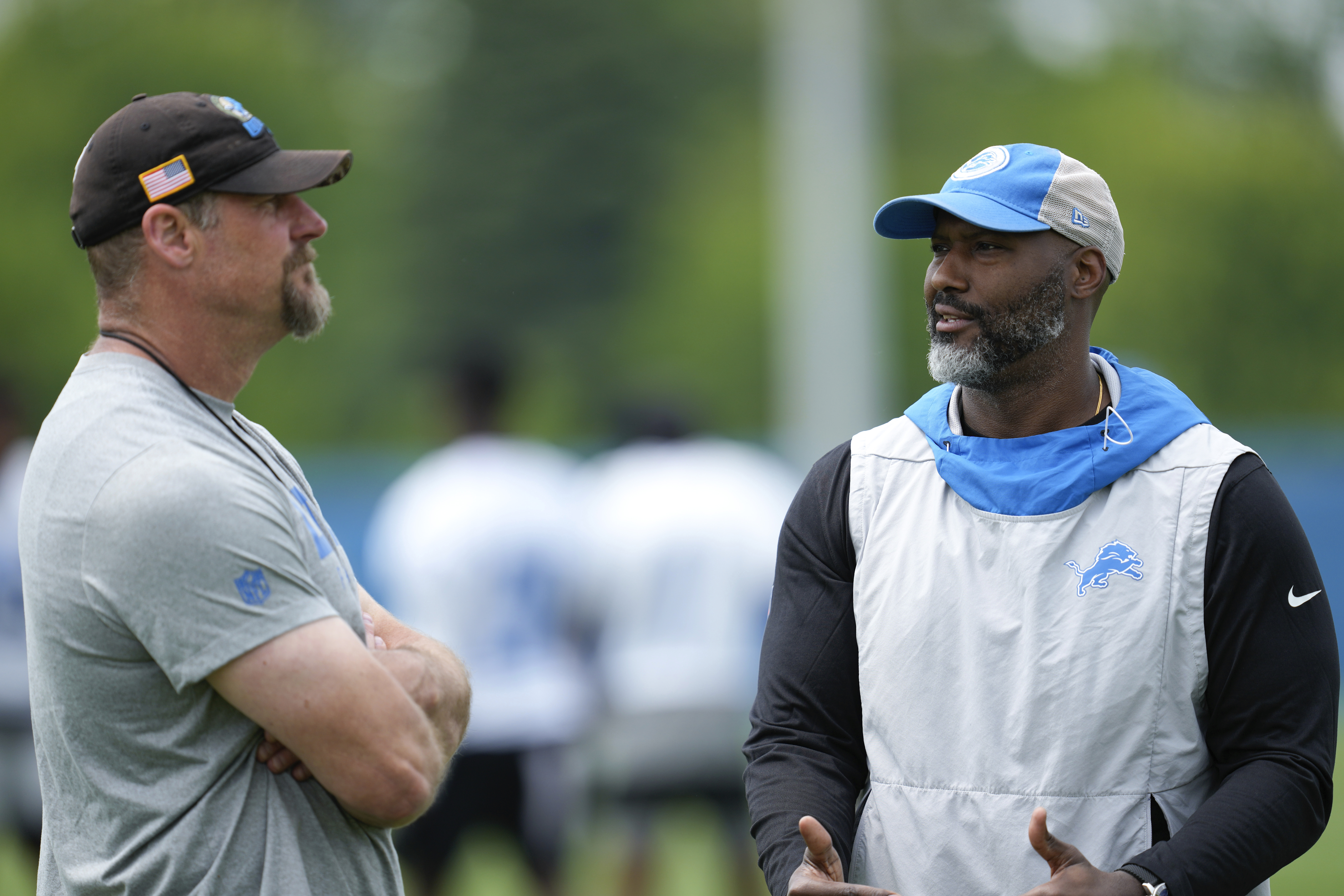 FILE - Detroit Lions head coach Dan Campbell, left, and general manager Brad Holmes, right, talk after an NFL football practice in Allen Park, Mich., June 6, 2023.