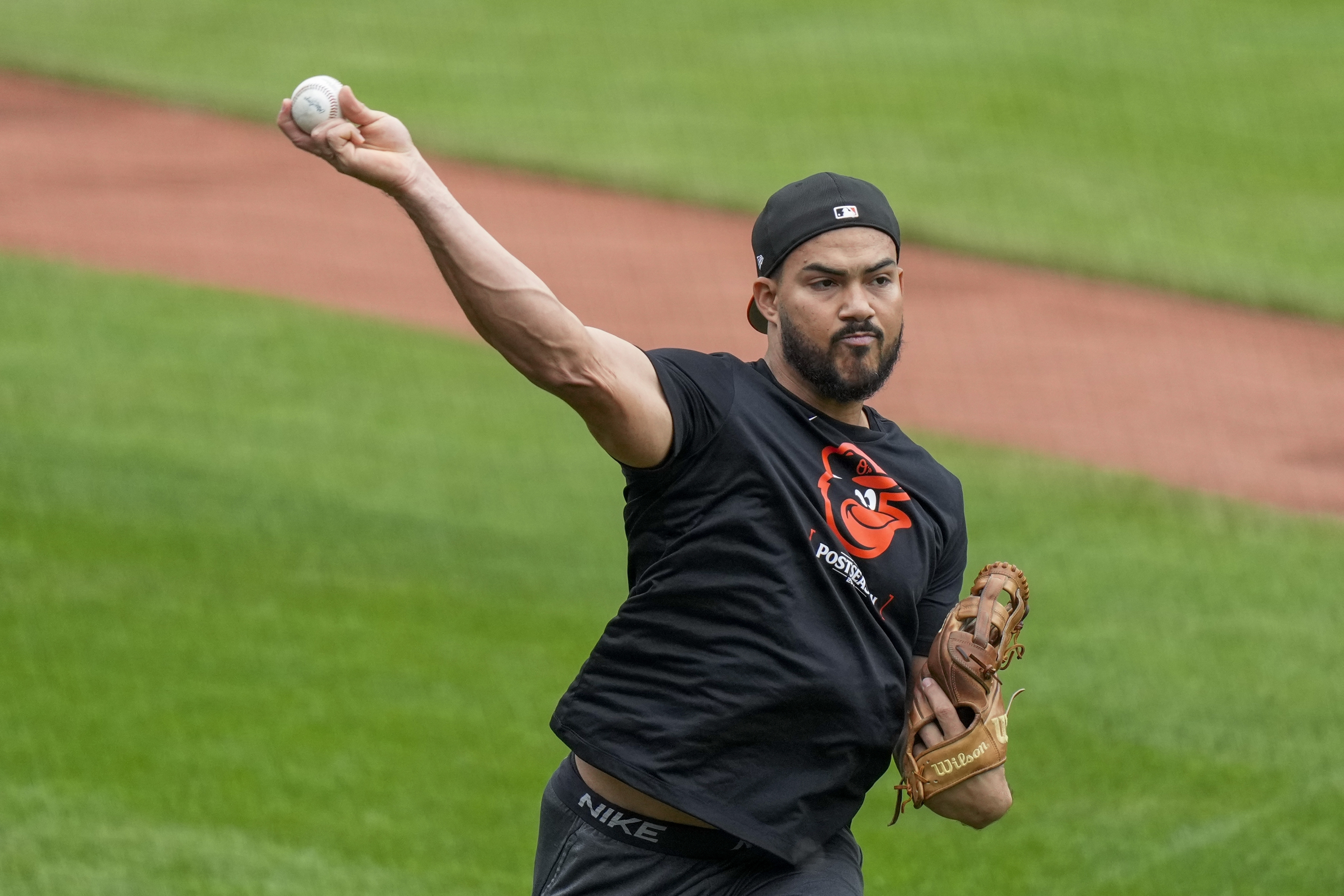 FILE - Baltimore Orioles right fielder Anthony Santander warms up during a baseball workout a day before the team's wild card playoff game against the Kansas City Royals, Monday, Sept. 30, 2024, in Baltimore.