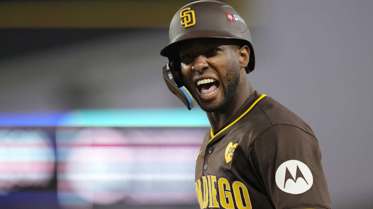 FILE - San Diego Padres' Jurickson Profar celebrates after hitting a bunt single during the sixth inning in Game 2 of a baseball NL Division Series against the Los Angeles Dodgers, Sunday, Oct. 6, 2024, in Los Angeles.