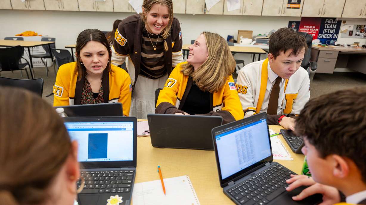 Davis High School student leaders Jetta Barber, Brina Lether, Emme Dahle, Spencer Monson work to verify names of former students who served in the armed forces over the years, on Jan. 17, for a wall inside the school to display all the names.