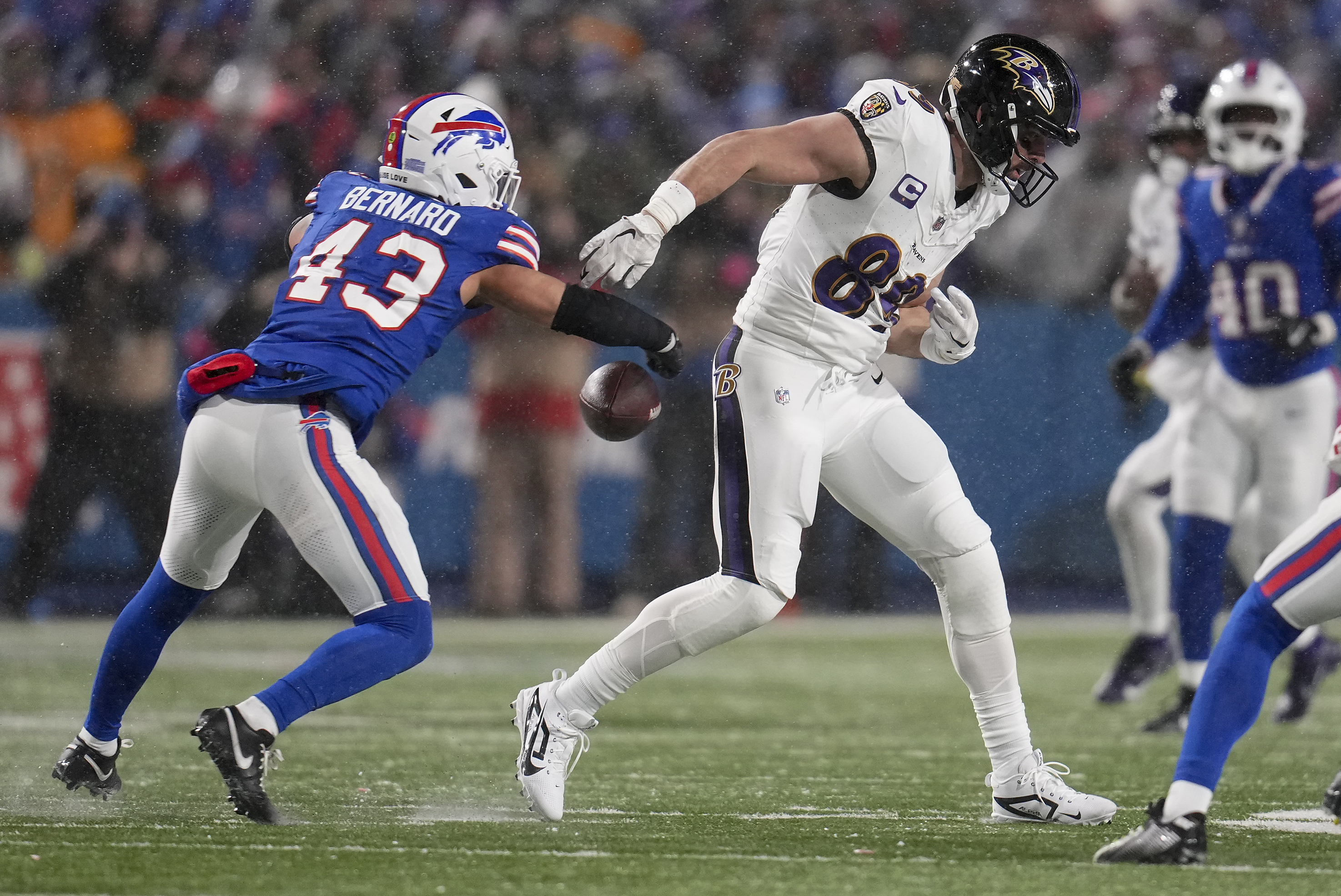 Buffalo Bills linebacker Terrel Bernard (43) strips the ball from Baltimore Ravens tight end Mark Andrews (89) during the fourth quarter of an NFL divisional playoff football game, Sunday, Jan. 19, 2025, in Orchard Park, N.Y.