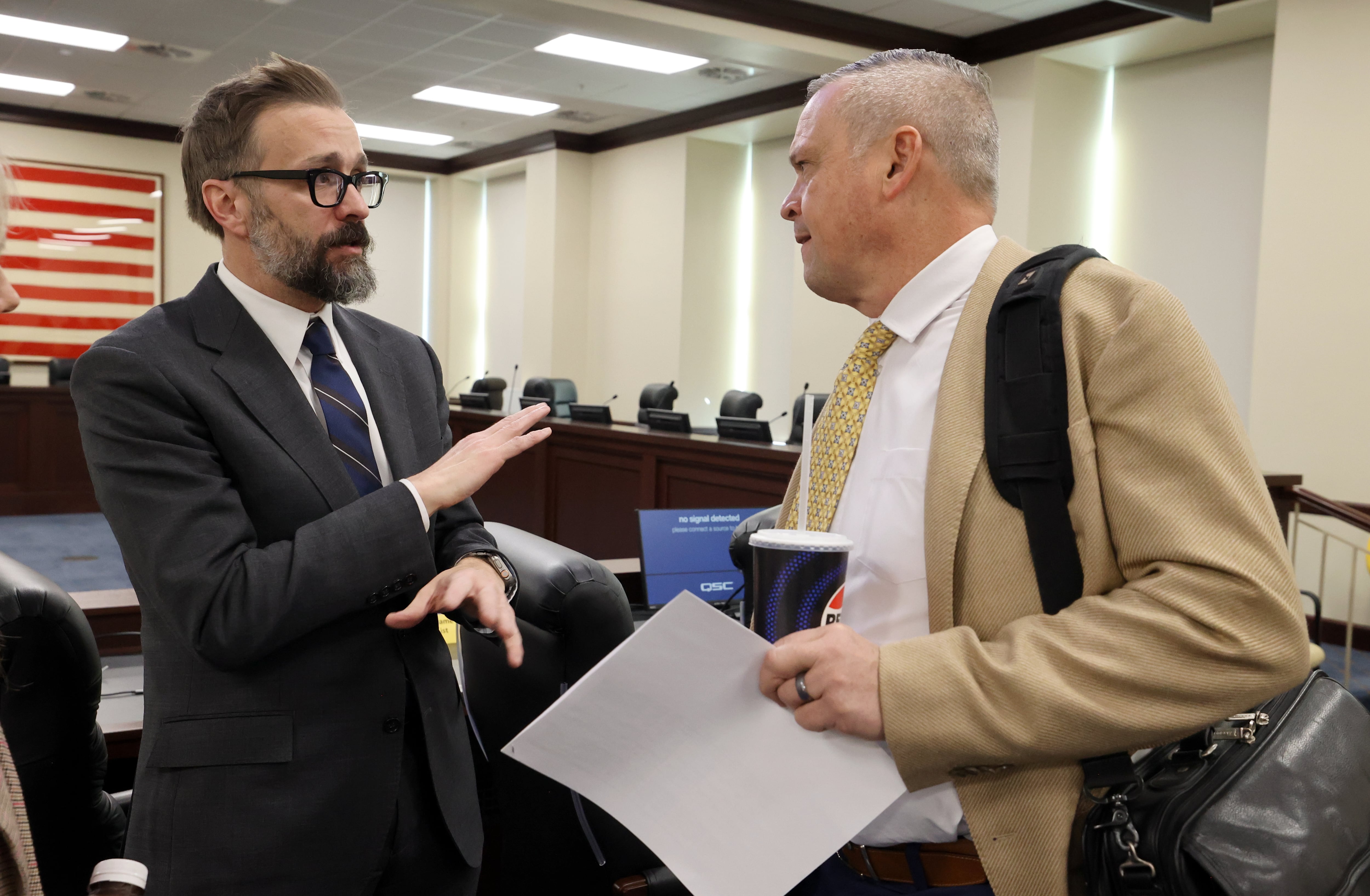 Utah System of Higher Education Commissioner Geoffrey Landward talks with Rep. Mark Strong, R-Bluffdale, after a meeting with the Higher Education Appropriations Subcommittee in the Senate Building in Salt Lake City on Thursday.