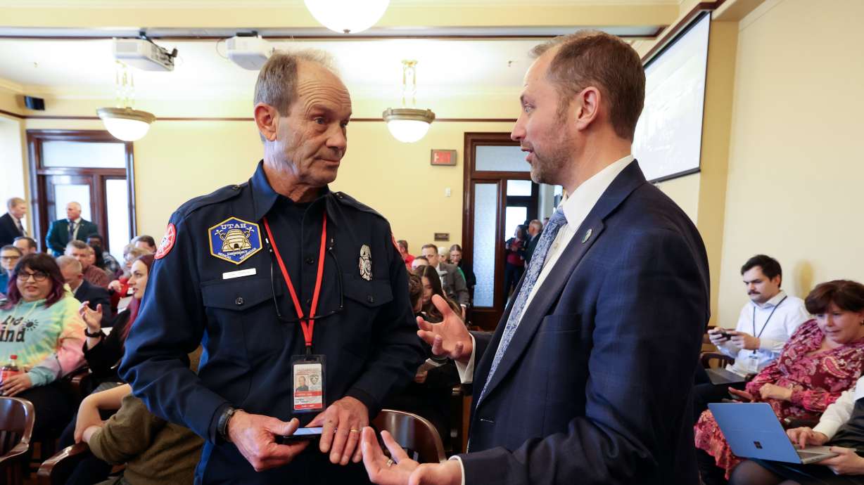 Jack Tidrow, Professional Firefighters of Utah president, talks with Rep. Jordan Teuscher, R-South Jordan, before Teuscher presented HB267 Public Sector Labor Union Amendments, which Tidrow opposes, during a House Business, Labor, and Commerce Committee meeting at the Capitol in Salt Lake City on Thursday. The committee voted to pass the bill.