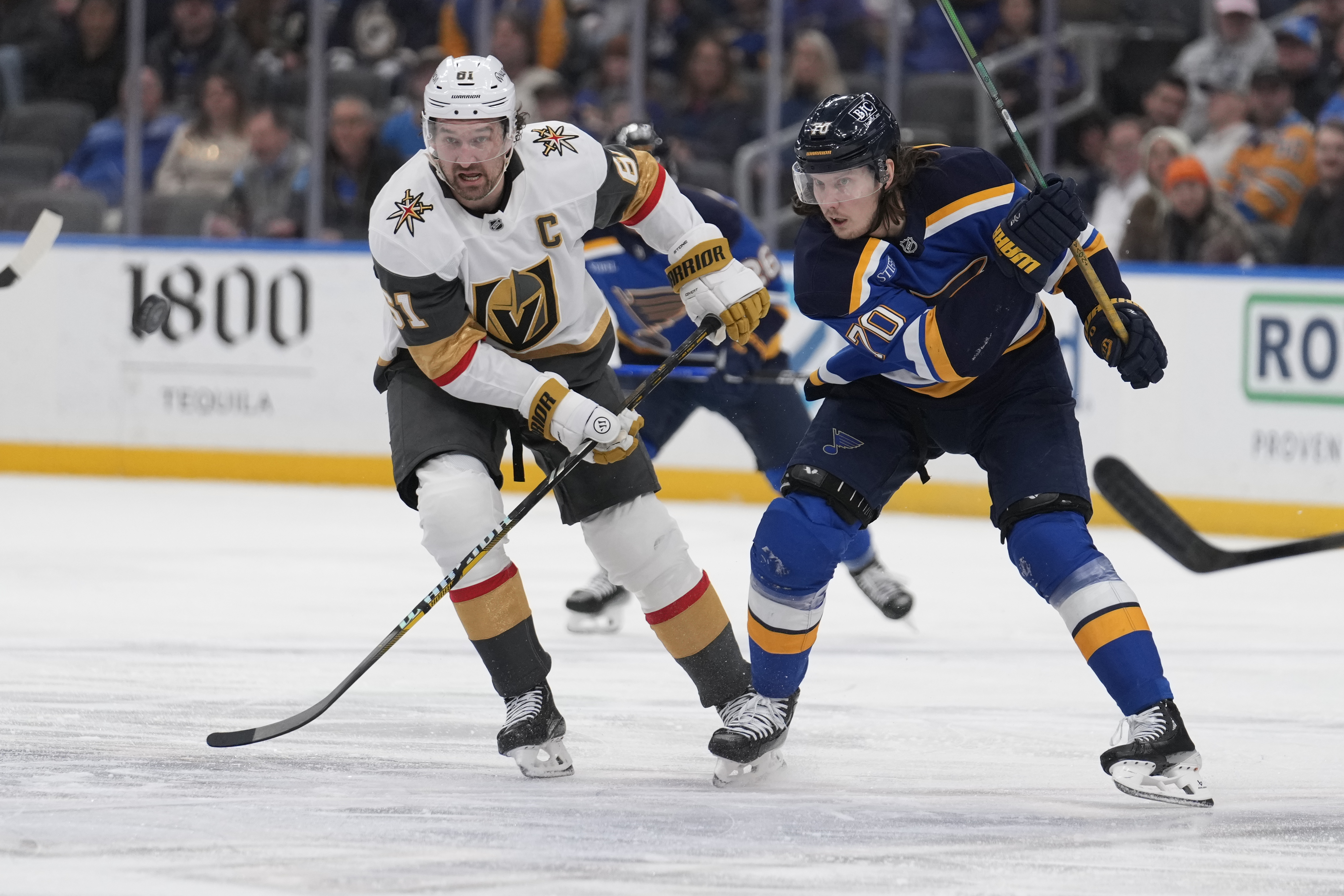 Vegas Golden Knights' Mark Stone (61) and St. Louis Blues' Oskar Sundqvist (70) chase after a loose puck during the second period of an NHL hockey game Thursday, Jan. 23, 2025, in St. Louis.