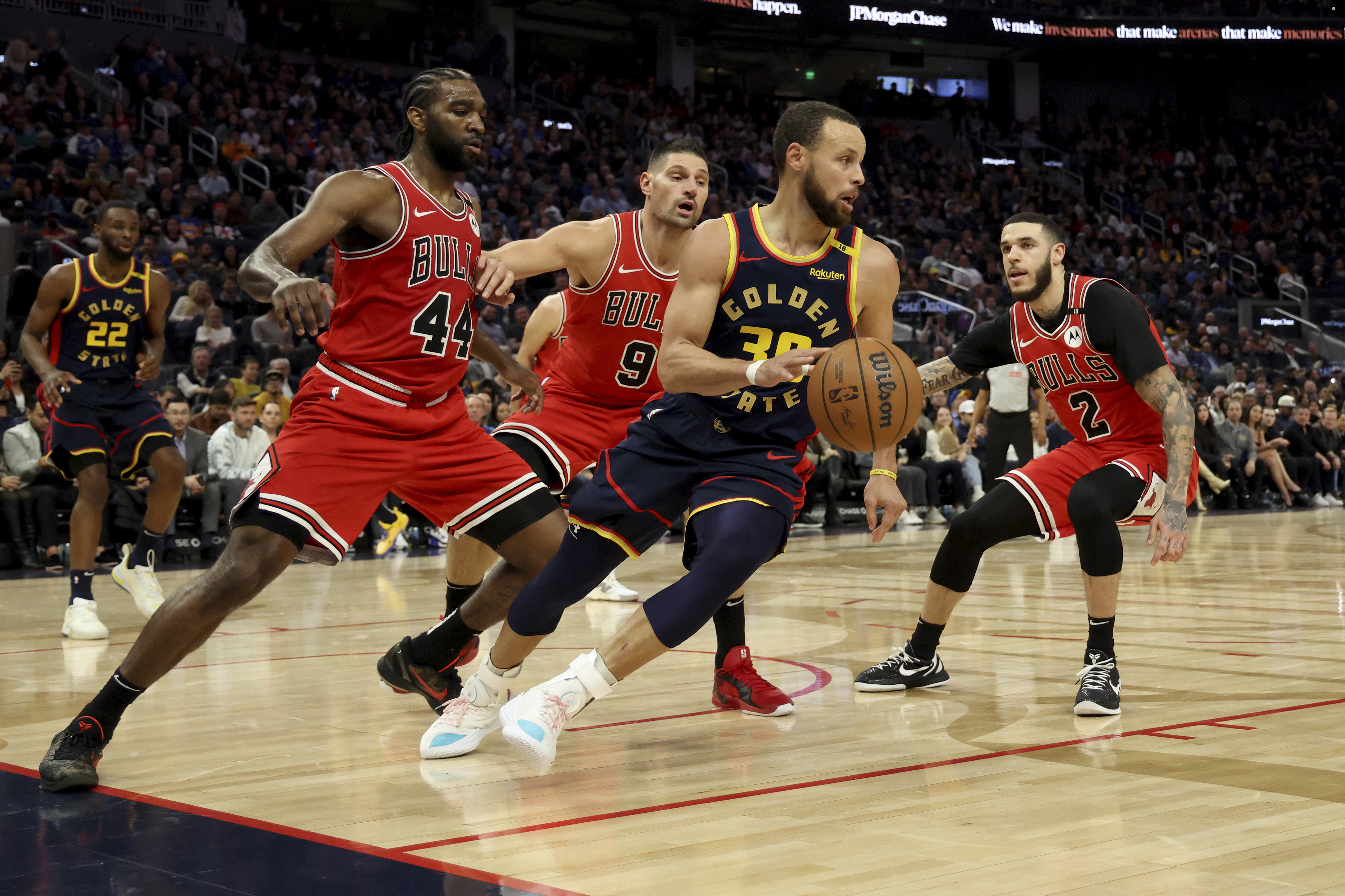 Golden State Warriors guard Stephen Curry (30) is defended by Chicago Bulls forward Patrick Williams (44), center Nikola Vucevic (9) and guard Lonzo Ball (2) during the first half of an NBA basketball game in San Francisco, Thursday, Jan. 23, 2025.