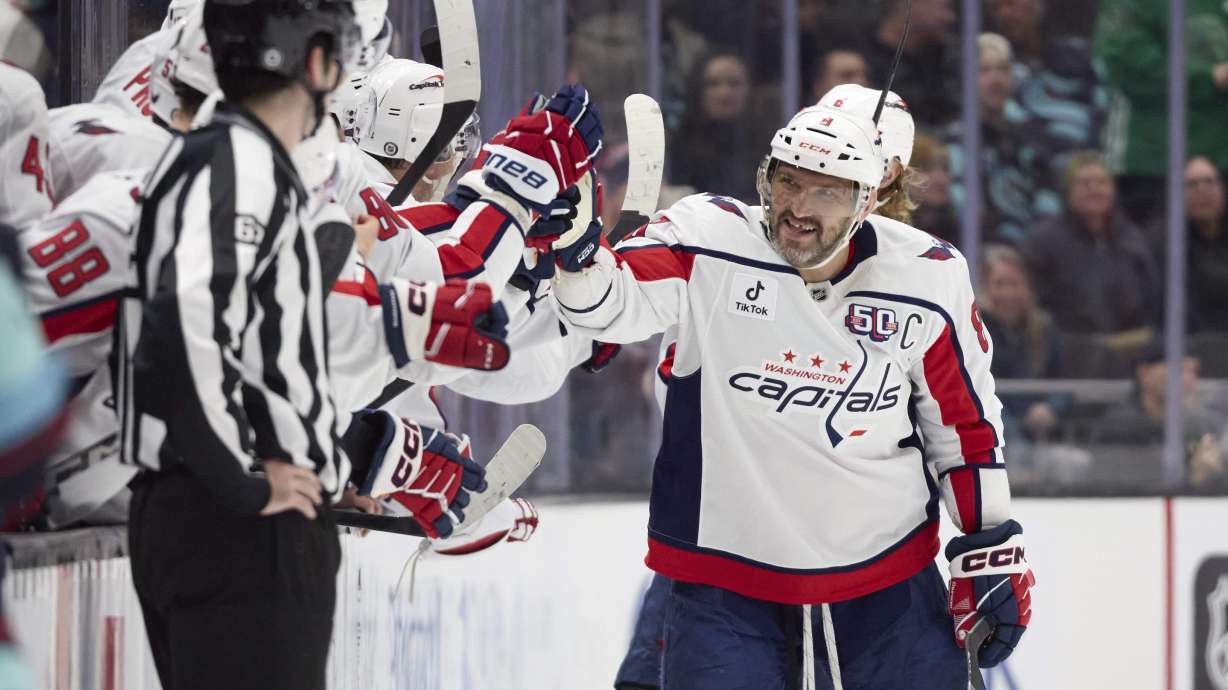 Washington Capitals left wing Alex Ovechkin (8) is congratulated after scoring against the Seattle Kraken during the third period of an NHL hockey game, Thursday, Jan. 23, 2025, in Seattle.