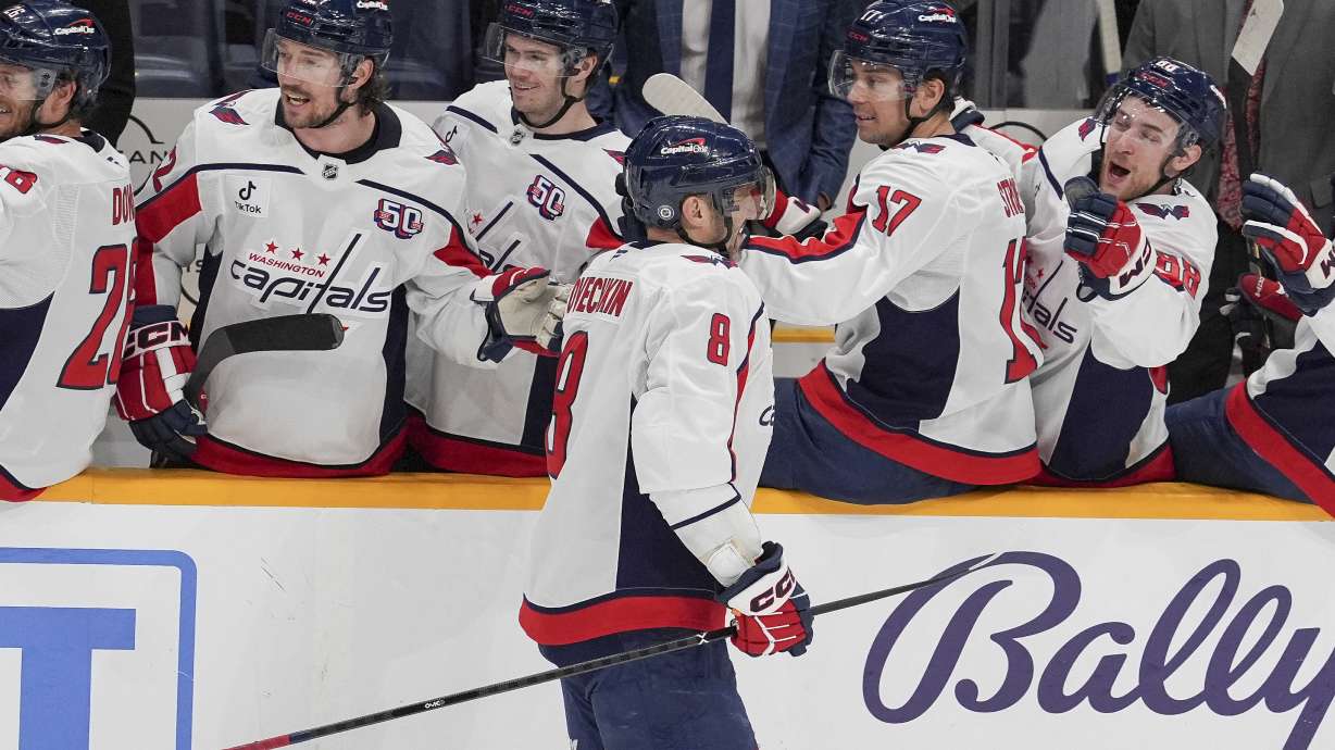 Washington Capitals left wing Alex Ovechkin (8) celebrates his empty net goal with teammates during the third period of an NHL hockey game against the Nashville Predators, Saturday, Jan. 11, 2025, in Nashville, Tenn. The Capitals won 4-1.