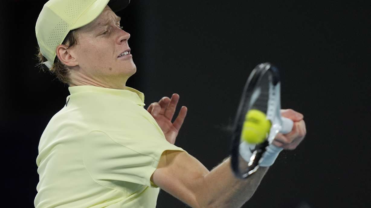 Jannik Sinner of Italy plays a forehand return to Ben Shelton of the U.S. during their semifinal match at the Australian Open tennis championship in Melbourne, Australia, Friday, Jan. 24, 2025.