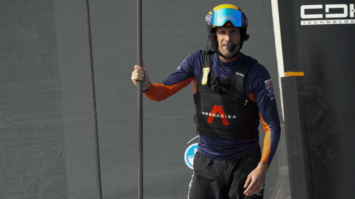 FILE - Ineos Britannia skipper Ben Ainslie, center santds before the Louis Vuitton 37th America's Cup Day 2 race in Barcelona, Spain, Sunday, Oct. 13, 2024.
