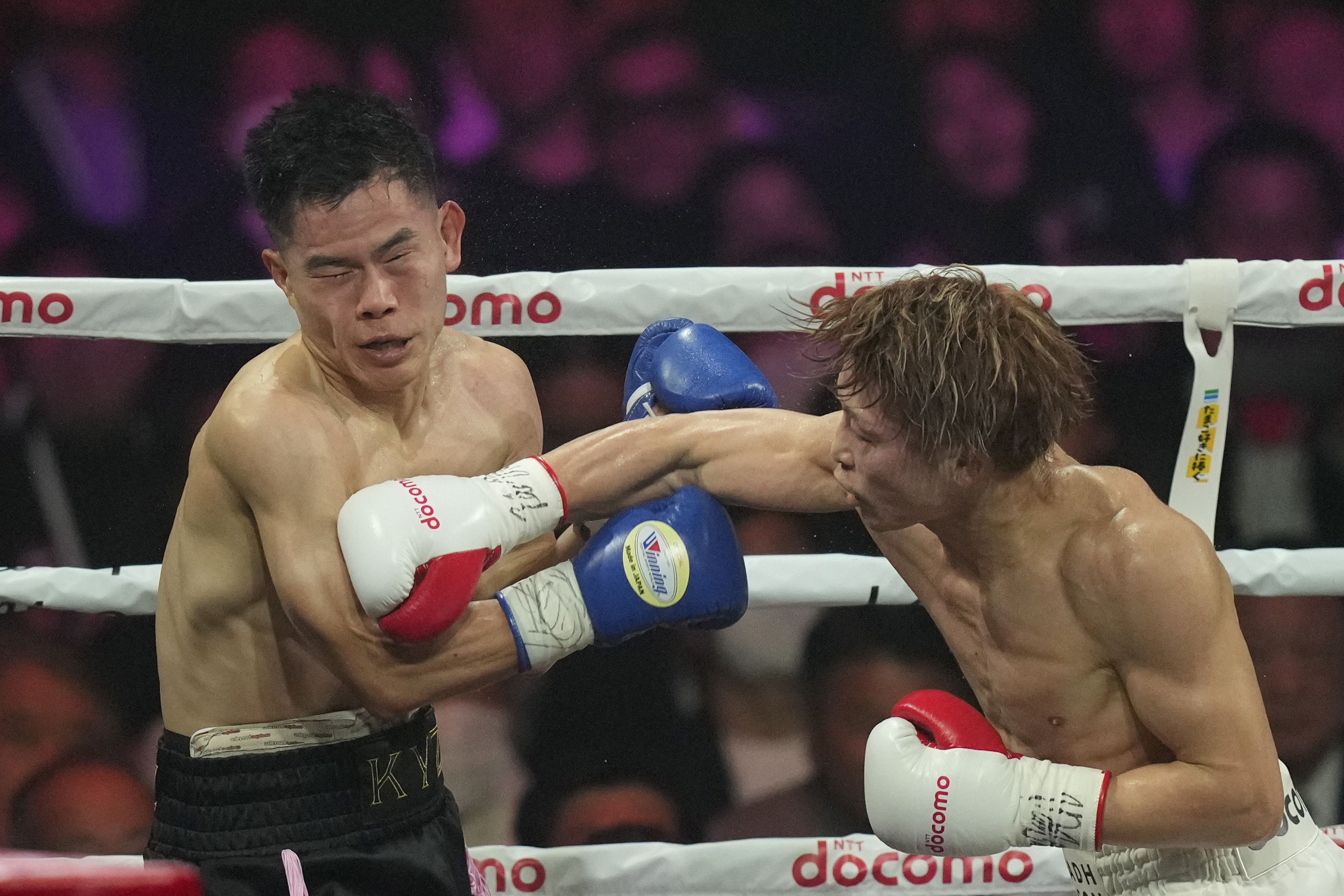 Japanese champion Naoya Inoue, right, punches South Korea challenger Ye Joon Kim during the unified WBC IBF and WBO super bantamweight world title at the Ariake Arena in Tokyo, Friday, Jan.24, 2025. 