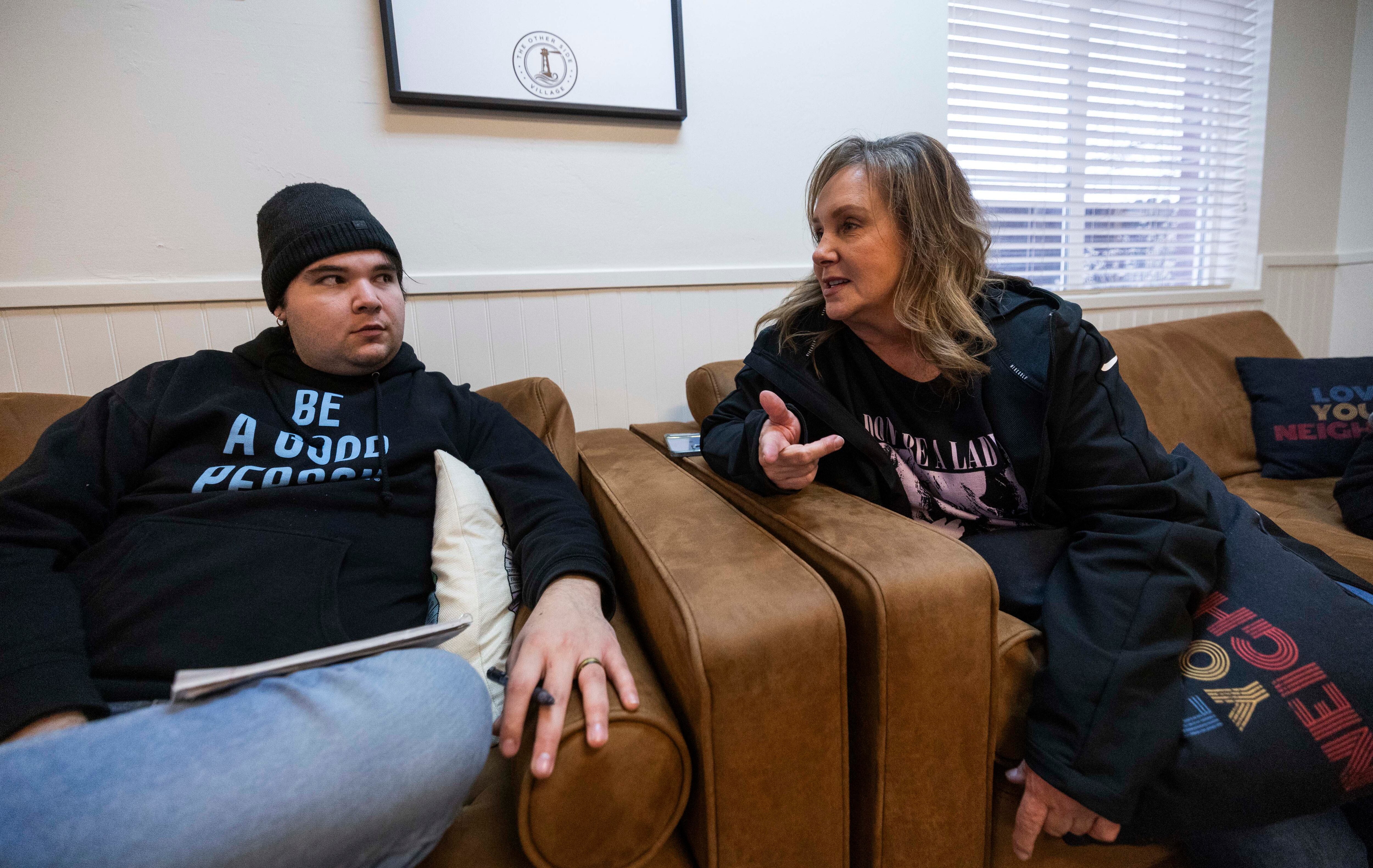 Other Side Village coach Marci Slaugh talks with her student Joseph during a skills lesson on habits at the Other Side Village campus in Murray on Friday.
