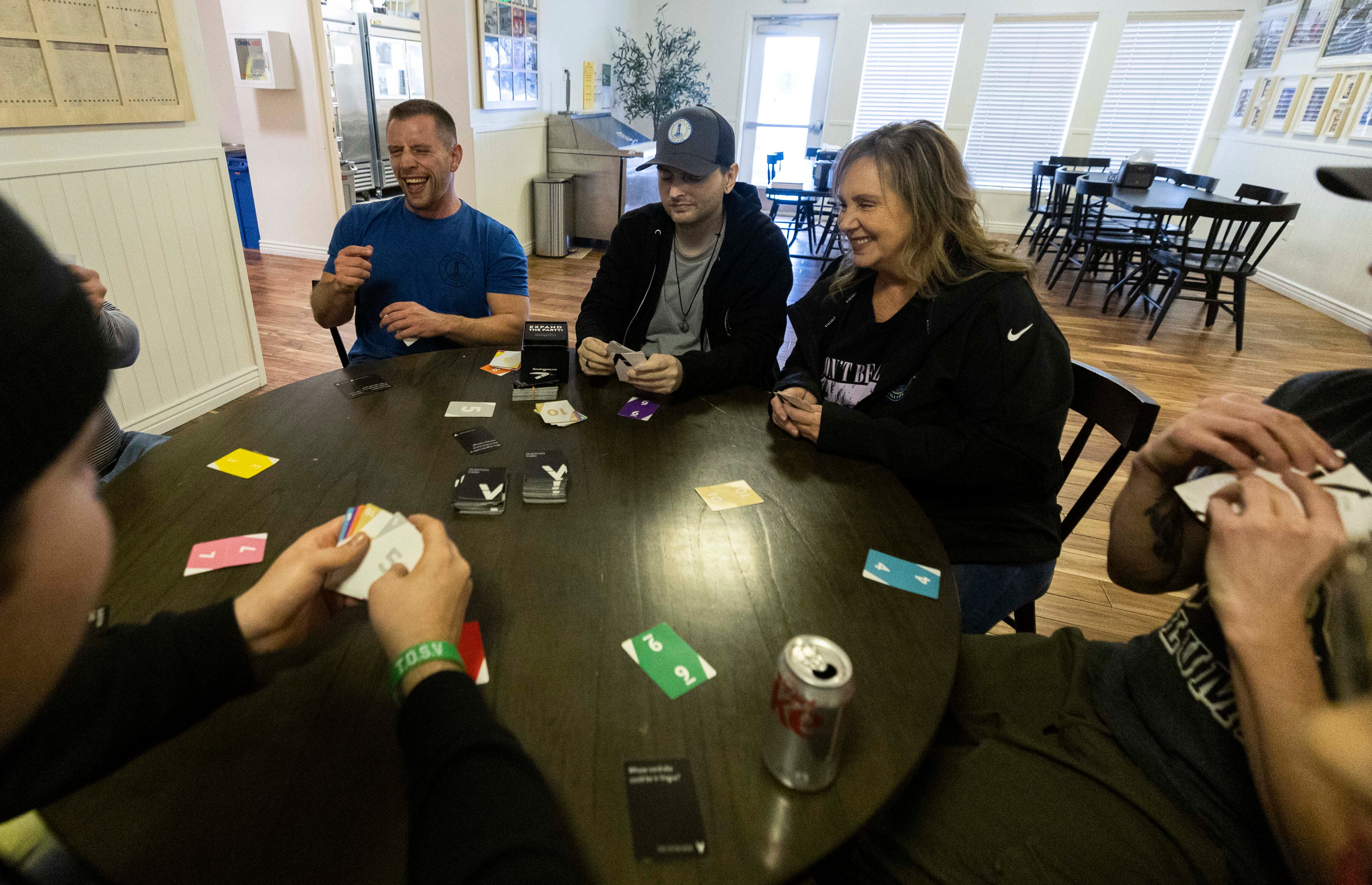 Other Side Village coaches Rob Myrick, left, and Marci Slaugh, right, play a game with their students after a skills lesson at the Other Side Village campus in Murray on Friday.