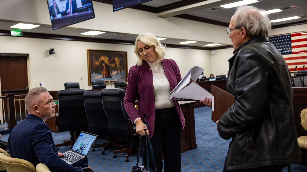 House Majority Whip Karianne Lisonbee, R-Syracuse, center, sits down after sponsoring HB252 in the Senate Committee room at the Capitol in Salt Lake City on Friday.