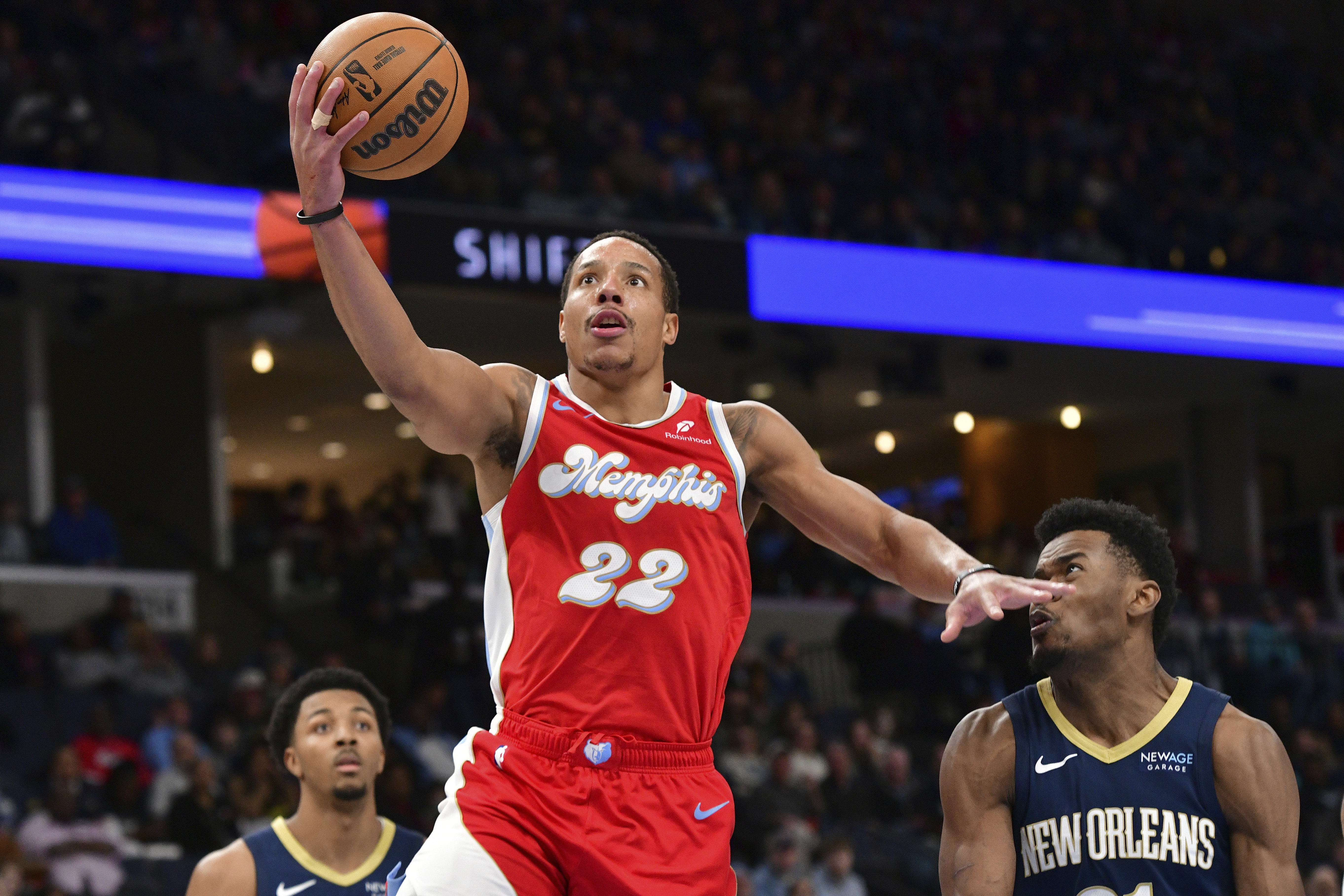 Memphis Grizzlies guard Desmond Bane (22) shoots ahead of New Orleans Pelicans center Yves Missi, right, in the second half of an NBA basketball game Friday, Jan. 24, 2025, in Memphis, Tenn.