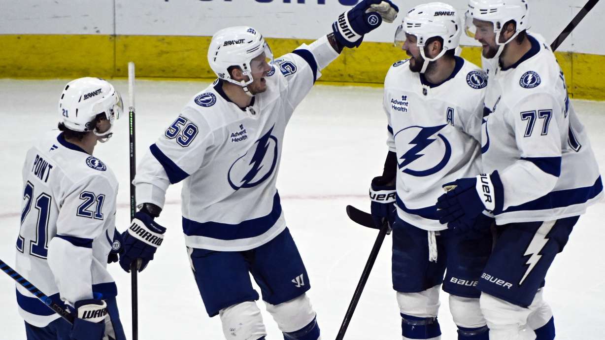 Tampa Bay Lightning right wing Nikita Kucherov, second from right, celebrates with teammates after scoring the winning goal during the overtime period of an NHL hockey game against the Chicago Blackhawks, Friday, Jan. 24, 2025, in Chicago.