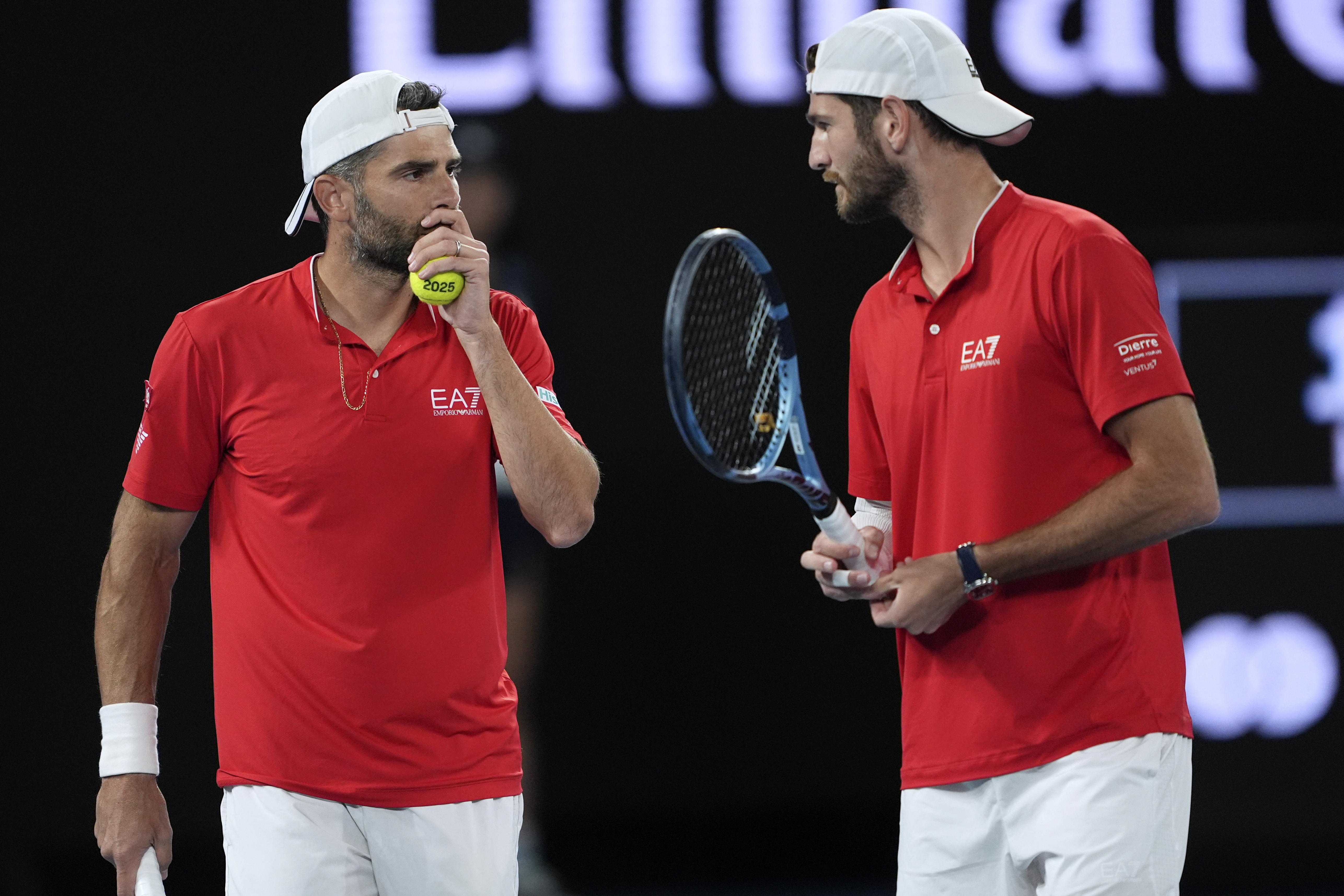Italy's Simone Bolelli and compatriot Andrea Vavassori react against Harri Heliovaara of Finland and Henry Patten of Britain in the men's doubles final at the Australian Open tennis championship in Melbourne, Australia, Saturday, Jan. 25, 2025.