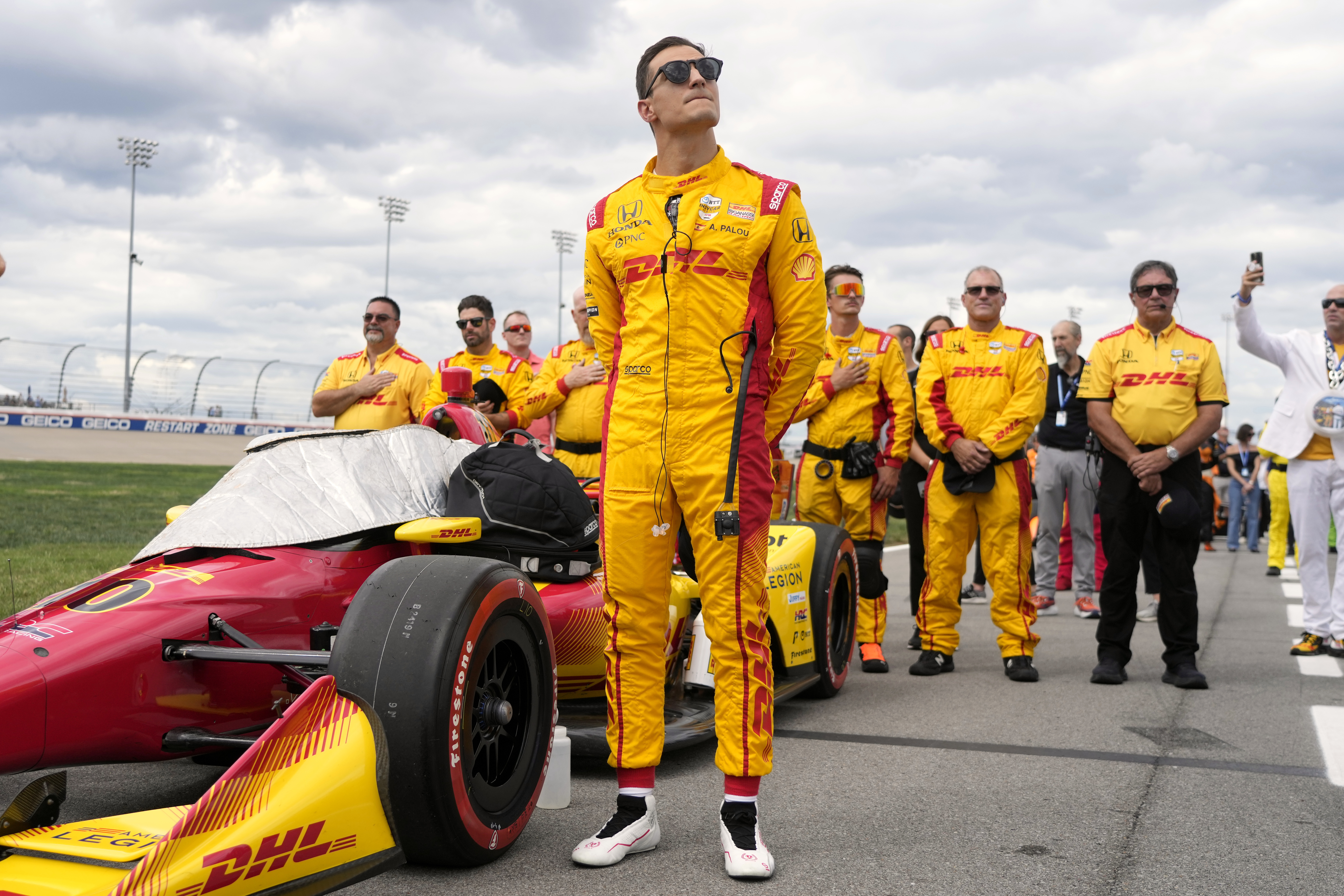 FILE - Alex Palou stands with his crew during the national anthem before an IndyCar auto race Sunday, Sept. 15, 2024, at the Nashville Superspeedway in Lebanon, Tenn.