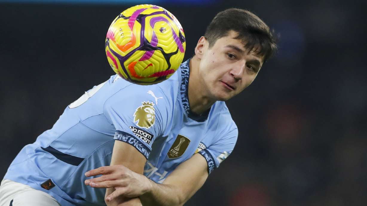 Manchester City's Abdukodir Khusanov heads the ball during the English Premier League soccer match between Manchester City and Chelsea at Etihad Stadium in Manchester, England, Saturday, Jan. 25, 2025.
