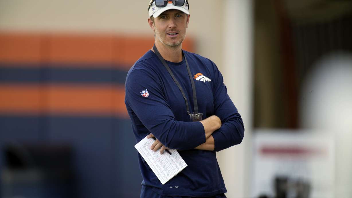 FILE - Denver Broncos director of player personnel Darren Mougey looks on as players take part in drills at NFL football training camp Friday, Aug. 6, 2021, in Englewood, Colo.