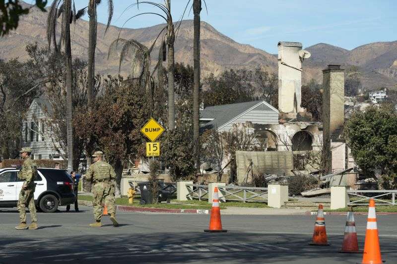 The National Guard and Los Angeles police guard a checkpoint as President Donald Trump sets to tour the Palisades Fire zone damage in the Pacific Palisades neighborhood of Los Angeles, Friday.