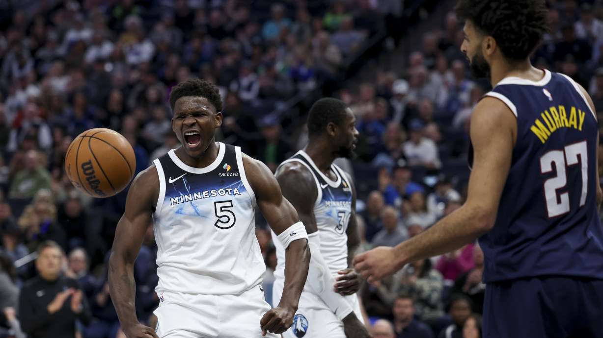 Minnesota Timberwolves guard Anthony Edwards (5) celebrates after scoring while Denver Nuggets guard Jamal Murray (27) reacts during the first half of an NBA basketball game, Saturday, Jan. 25, 2025, in Minneapolis.