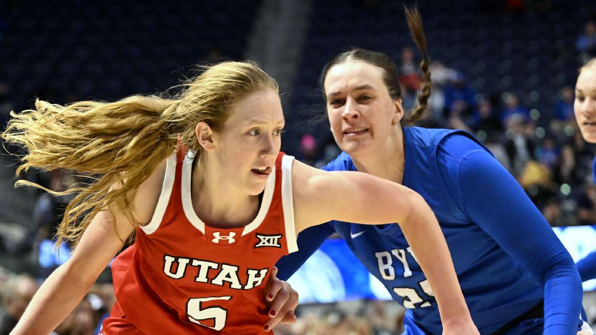 Utah Utes guard Gianna Kneepkens (5) drives on BYU Cougars forward Emma Calvert (25) as BYU and Utah women play at the Marriott Center in Provo on Saturday January 25, 2025.