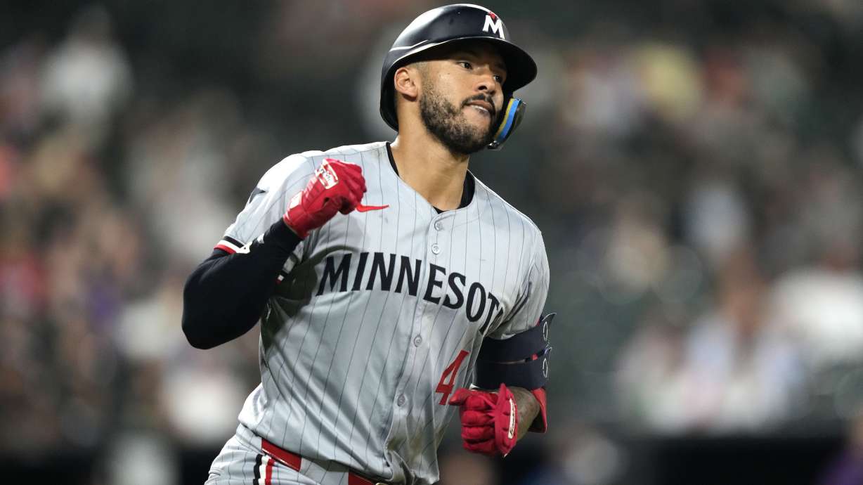 FILE - Minnesota Twins' Carlos Correa celebrates after his home run off Chicago White Sox relief pitcher Jordan Leasure during the seventh inning of a baseball game Monday, July 8, 2024, in Chicago.