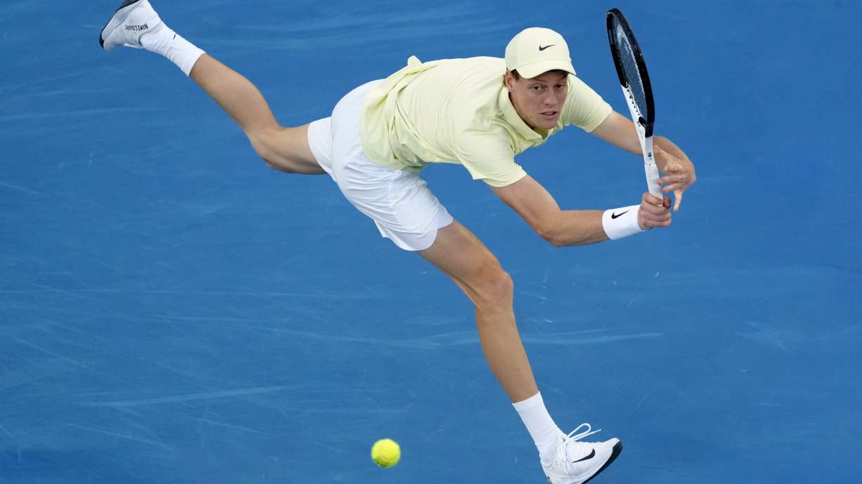 Jannik Sinner of Italy plays a backhand return to Ben Shelton of the U.S. during their semifinal match at the Australian Open tennis championship in Melbourne, Australia, Friday, Jan. 24, 2025.