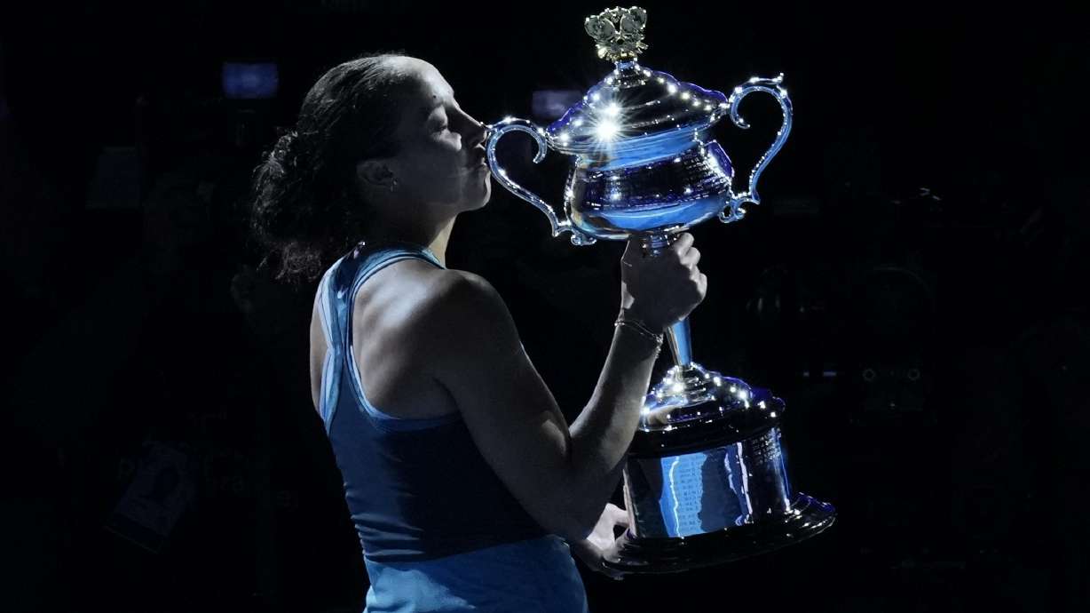 Madison Keys of the U.S. kisses the Daphne Akhurst Memorial Cup after defeating Aryna Sabalenka of Belarus in the women's singles final at the Australian Open tennis championship in Melbourne, Australia, Saturday, Jan. 25, 2025.