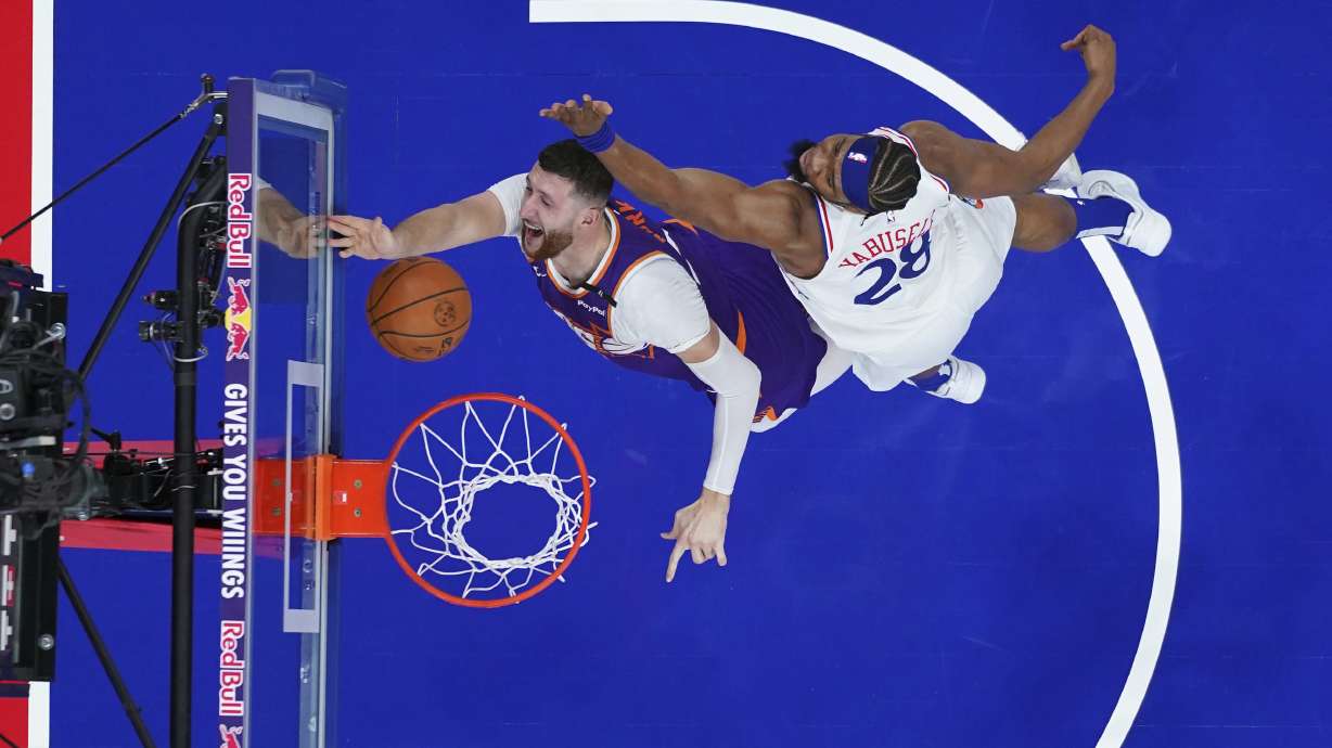 Phoenix Suns' Jusuf Nurkic, left, goes up for a shot against Philadelphia 76ers' Guerschon Yabusele during the first half of an NBA basketball game, Monday, Jan. 6, 2025, in Philadelphia.