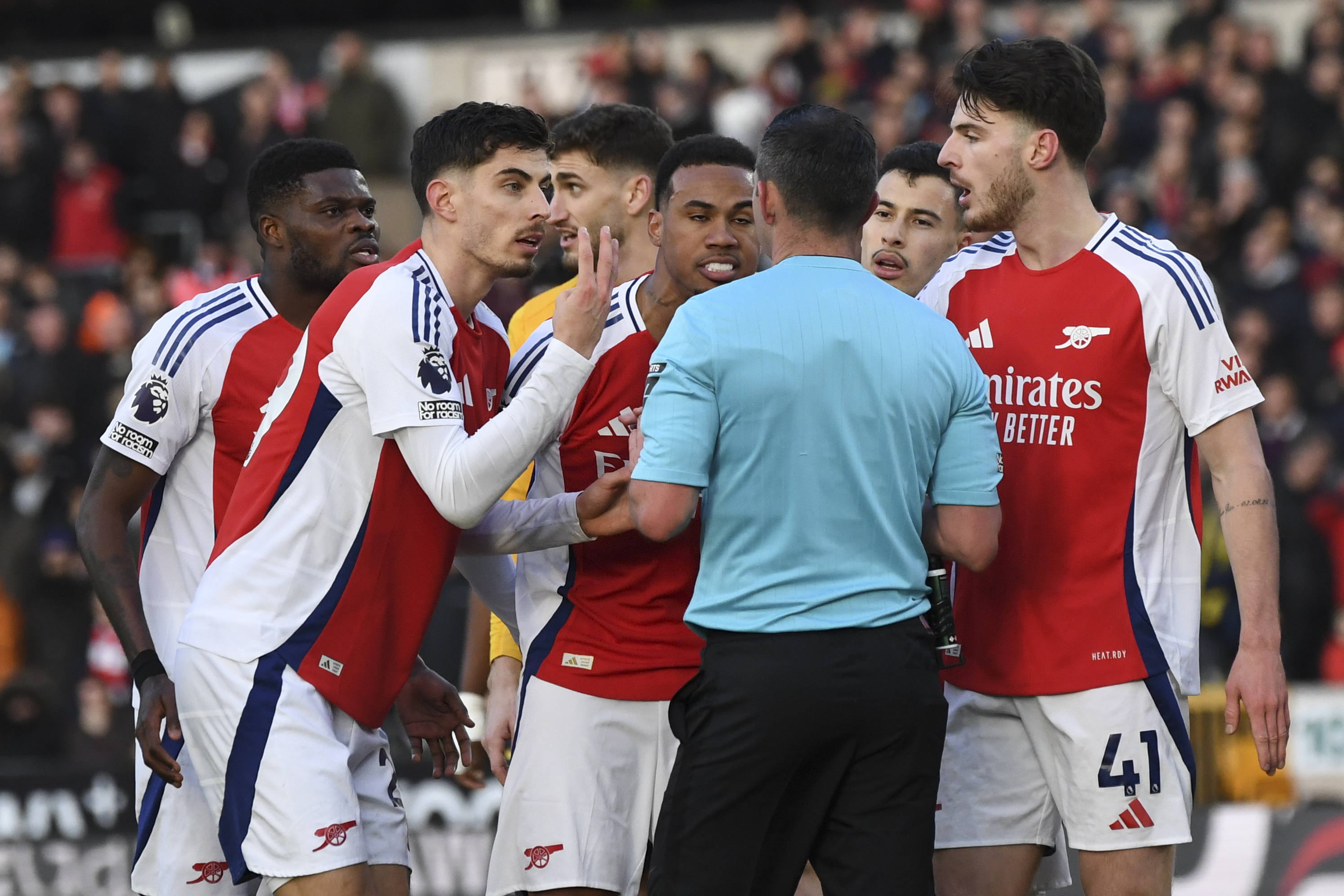 Arsenal's Kai Havertz, left, pleads with referee Michael Oliver after he sent off Arsenal's Myles Lewis-Skelli during the English Premier League soccer match between Wolverhampton Wanderers and Arsenal at the Molineux Stadium in Wolverhampton, England, Saturday, Jan. 25, 2025.