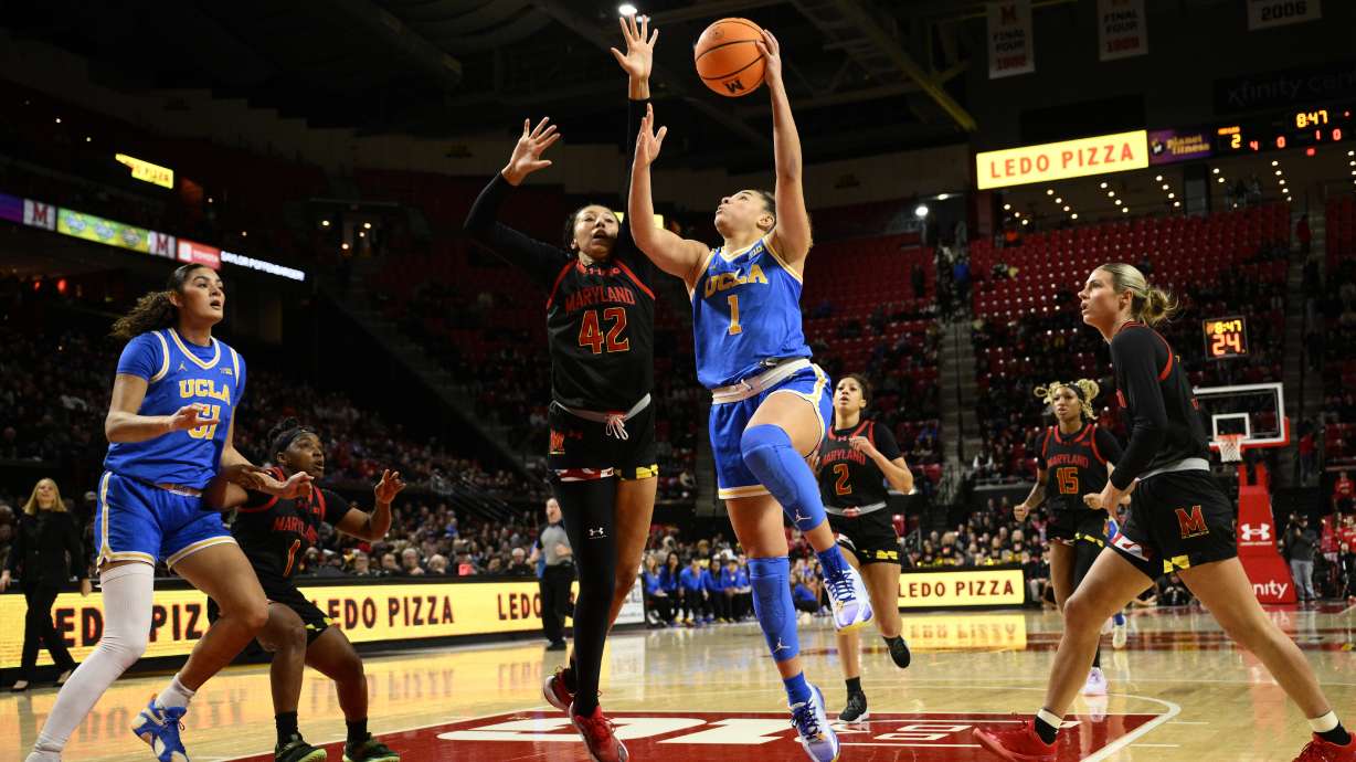 UCLA guard Kiki Rice (1) goes to the basket against Maryland forward Amari DeBerry (42) during the first half of an NCAA college basketball game, Sunday, Jan. 26, 2025, in College Park, Md.