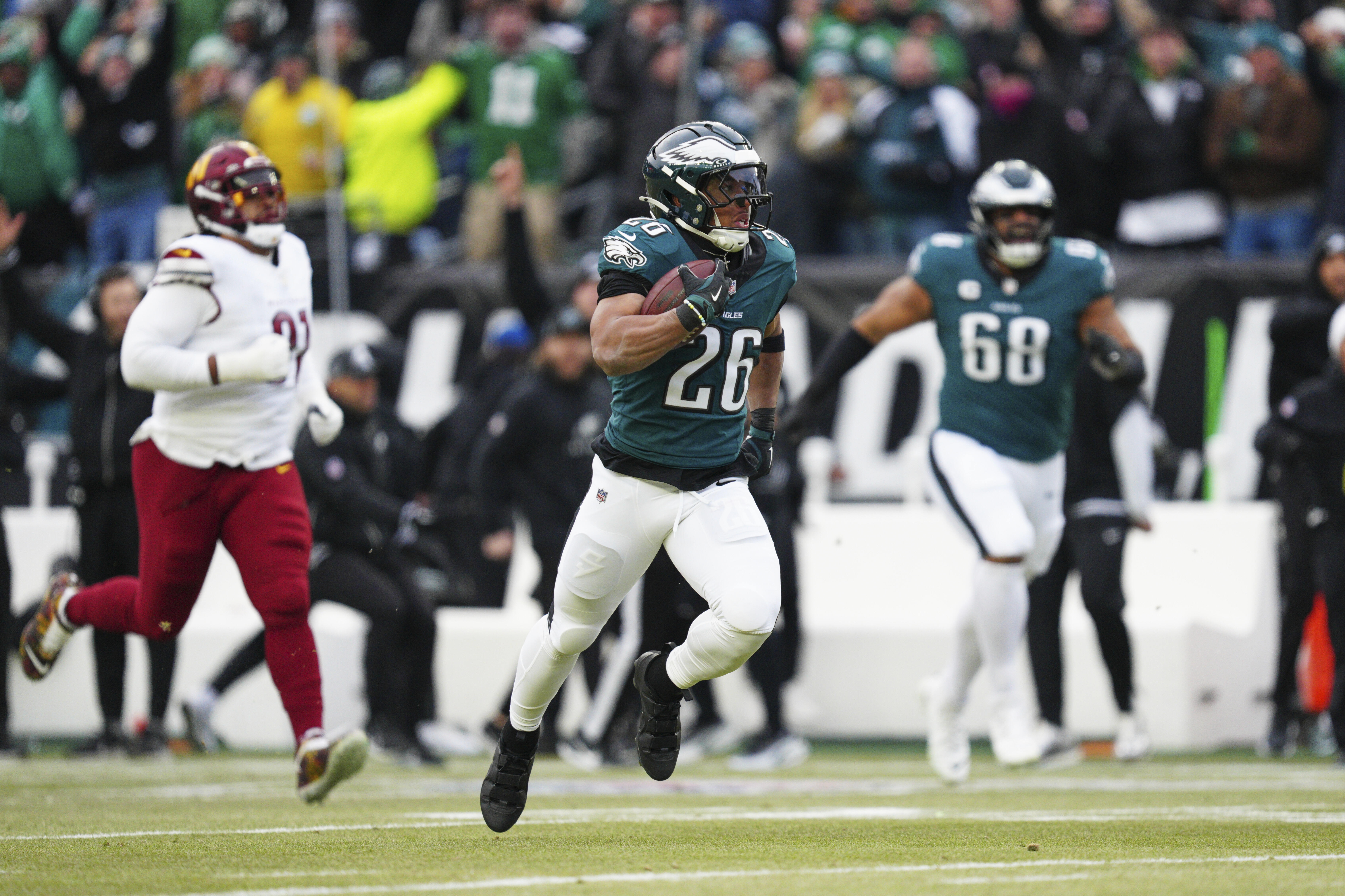 Philadelphia Eagles running back Saquon Barkley (26) runs for a touchdown against the Washington Commanders during the first half of the NFC Championship NFL football game, Sunday, Jan. 26, 2025, in Philadelphia. 