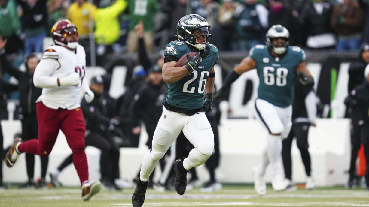 Philadelphia Eagles running back Saquon Barkley (26) runs for a touchdown against the Washington Commanders during the first half of the NFC Championship NFL football game, Sunday, Jan. 26, 2025, in Philadelphia.