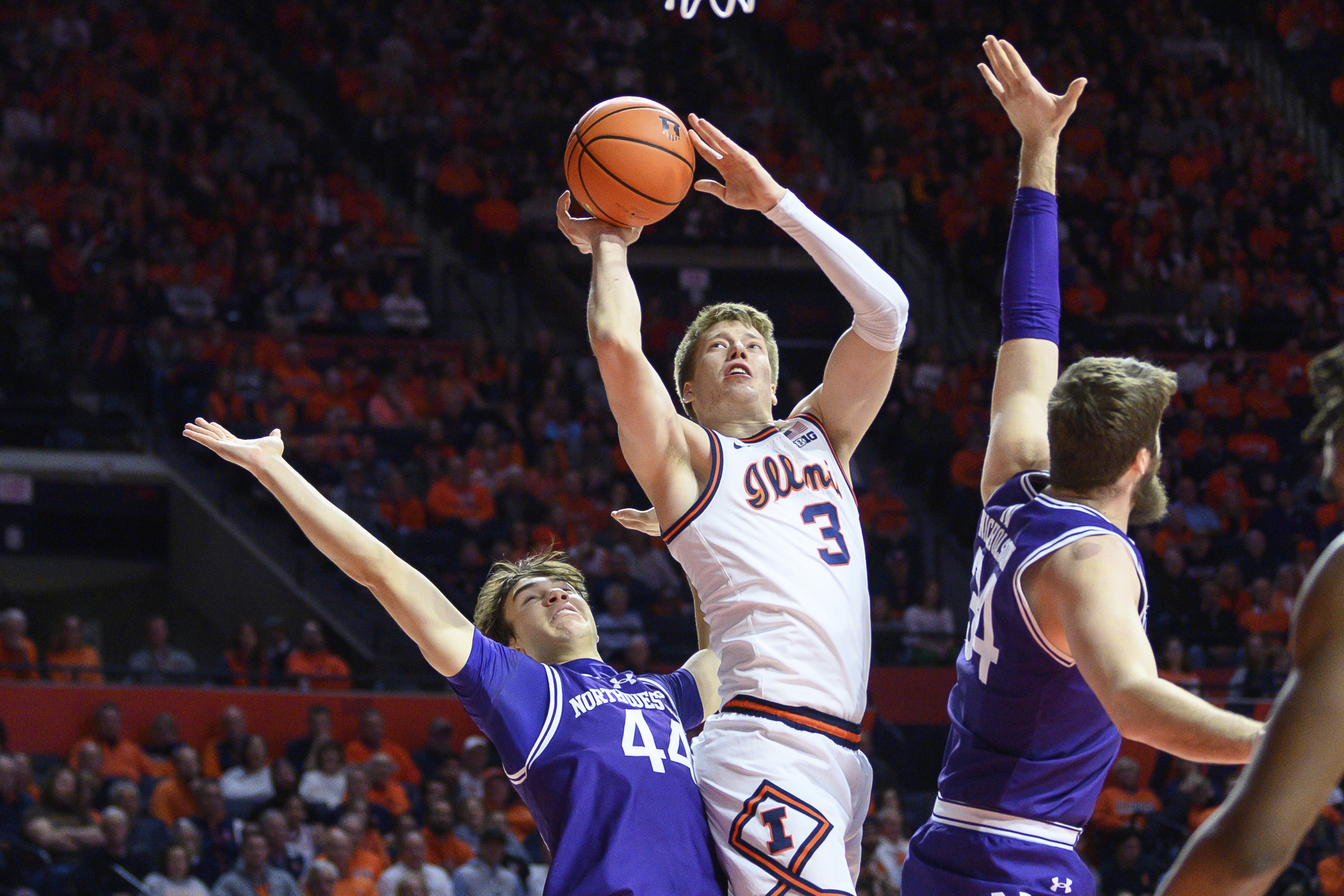 Illinois' Ben Humrichous (3) goes to the basket past Northwestern's Angelo Ciaravino, left, during the first half of an NCAA college basketball game Sunday, Jan. 26, 2025, in Champaign, Ill.