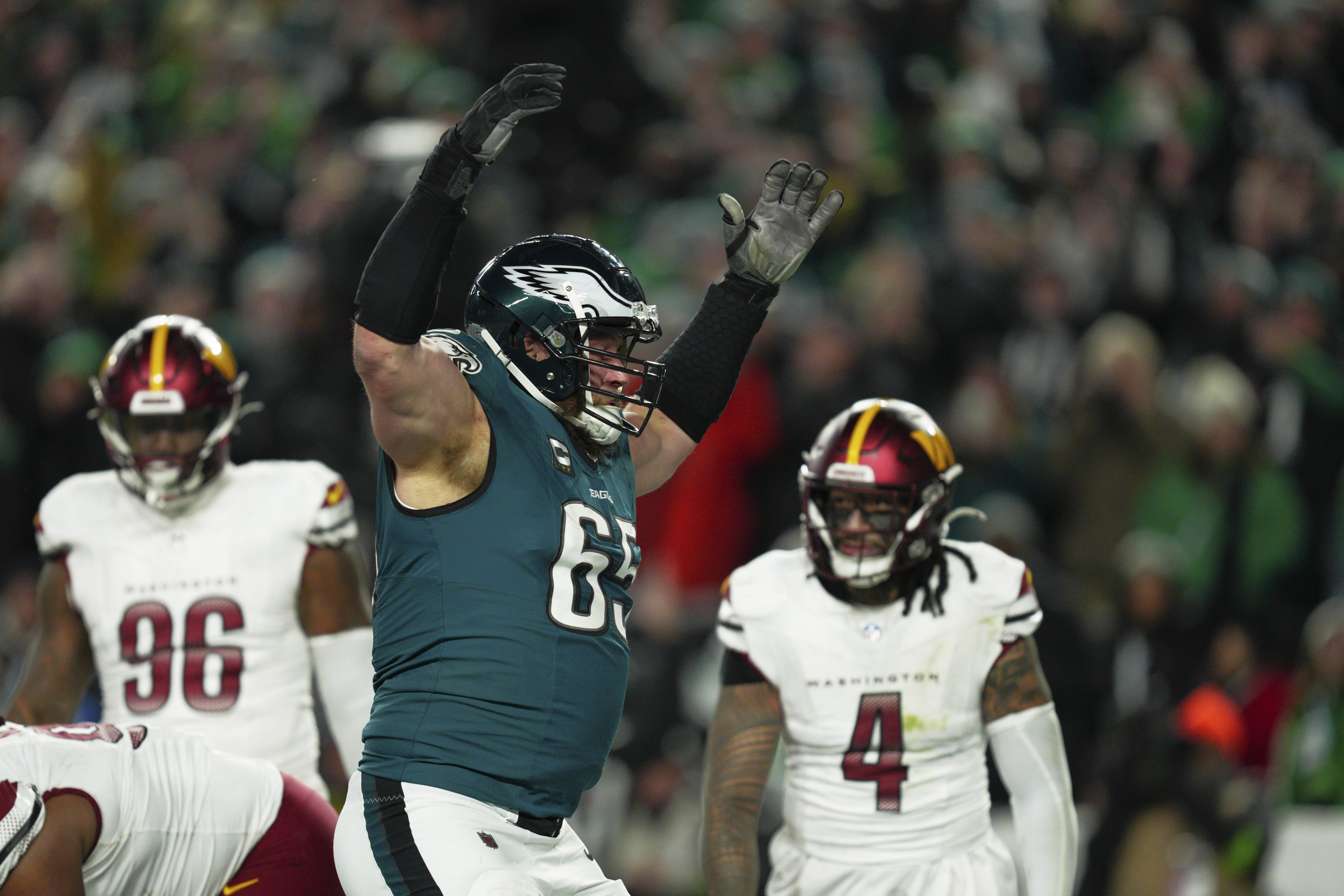 Philadelphia Eagles offensive tackle Lane Johnson (65) celebrates a touchdown by quarterback Jalen Hurts during the second half of the NFC Championship NFL football game against the Washington Commanders, Sunday, Jan. 26, 2025, in Philadelphia. 