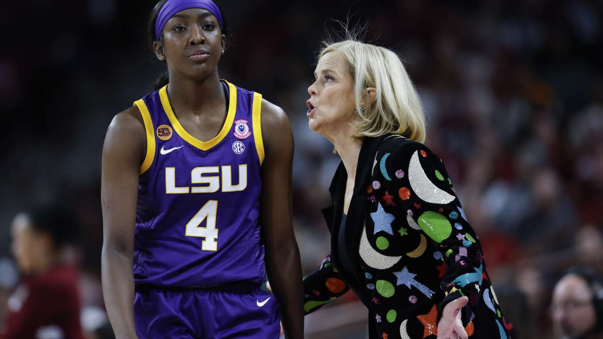 LSU head coach Kim Mulkey, right, talks to guard Flau'Jae Johnson who walks to the bench during the second half of an NCAA college basketball game against South Carolina in Columbia, S.C., Friday, Jan. 24, 2025.