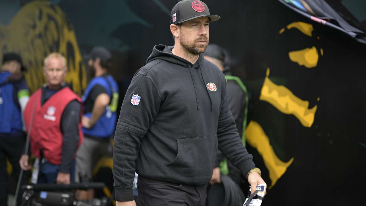 FILE - San Francisco 49ers offensive passing game specialist Klint Kubiak heads to the field before an NFL football game against the Jacksonville Jaguars, Nov. 12, 2023, in Jacksonville, Fla.