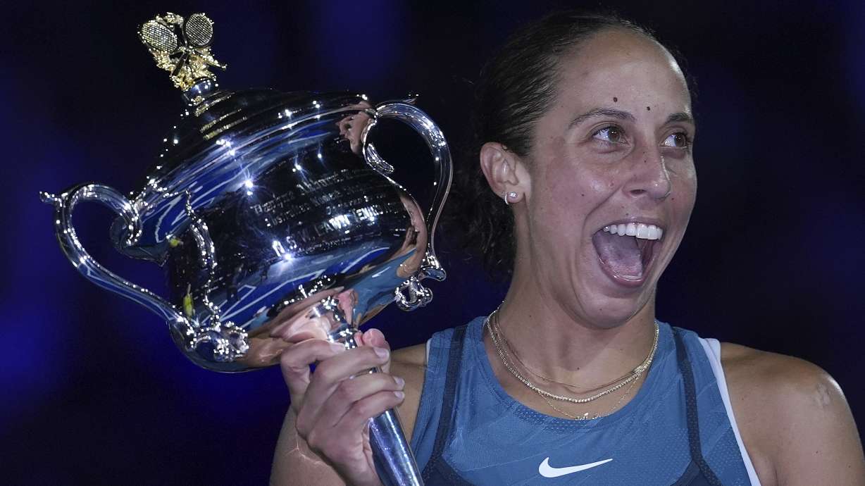 Madison Keys of the U.S. reacts as she receives the the Daphne Akhurst Memorial Cup from Evonne Goolagong Cawley after defeating Aryna Sabalenka of Belarus in the women's singles final at the Australian Open tennis championship in Melbourne, Australia, Saturday, Jan. 25, 2025.