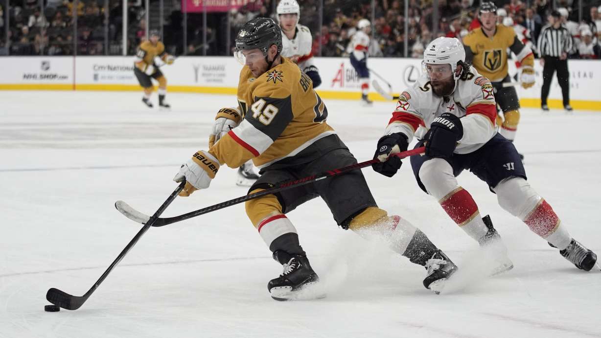 Vegas Golden Knights center Ivan Barbashev (49) and Florida Panthers defenseman Aaron Ekblad (5) vie for the puck during the second period of an NHL hockey game Sunday, Jan. 26, 2025, in Las Vegas.